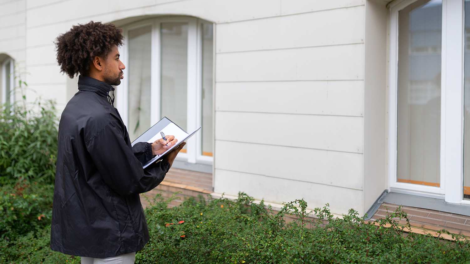 Inspector standing outside of home
