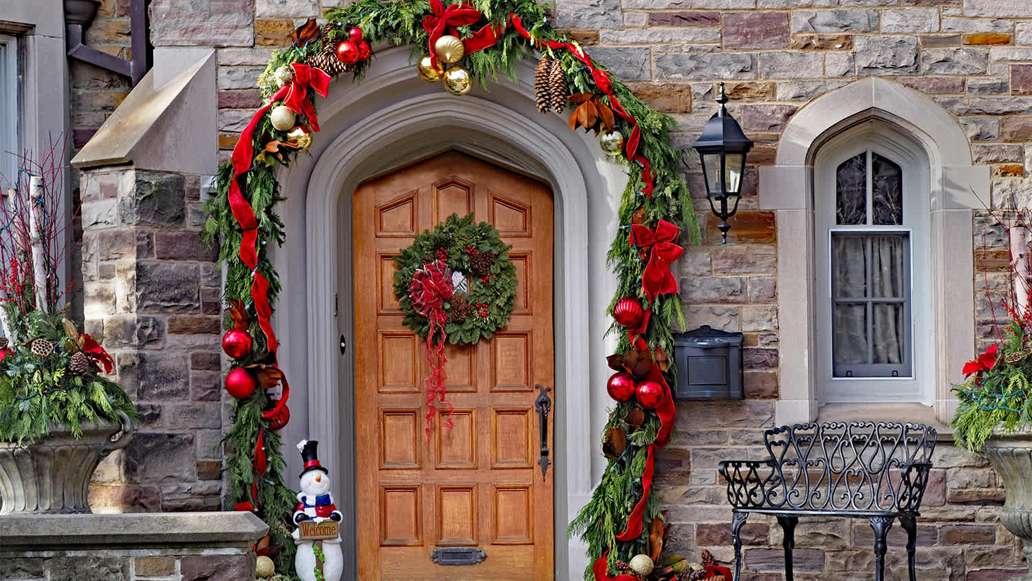 Christmas porch decorated with red ribbon