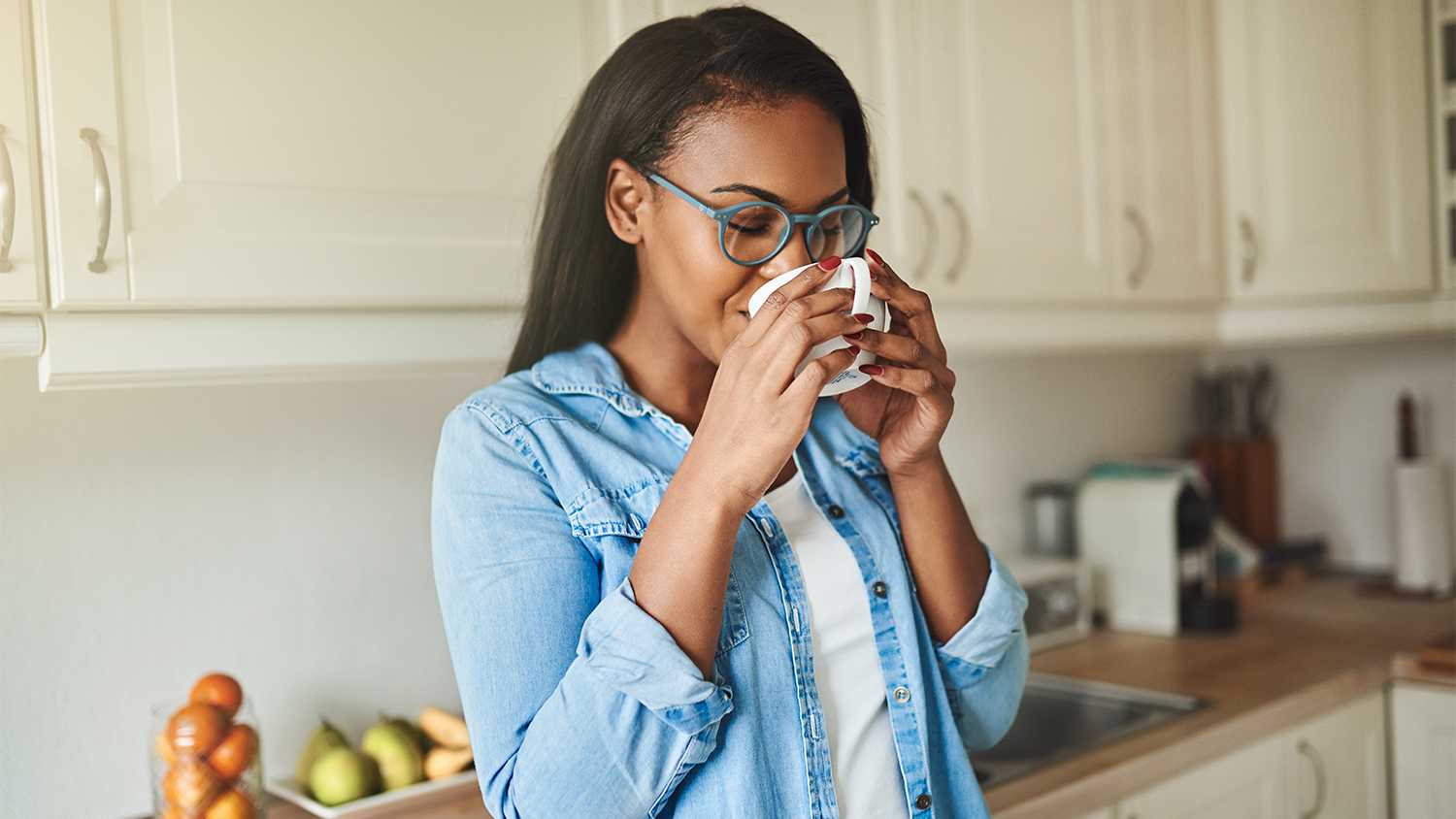Woman drinking coffee and looking out the window