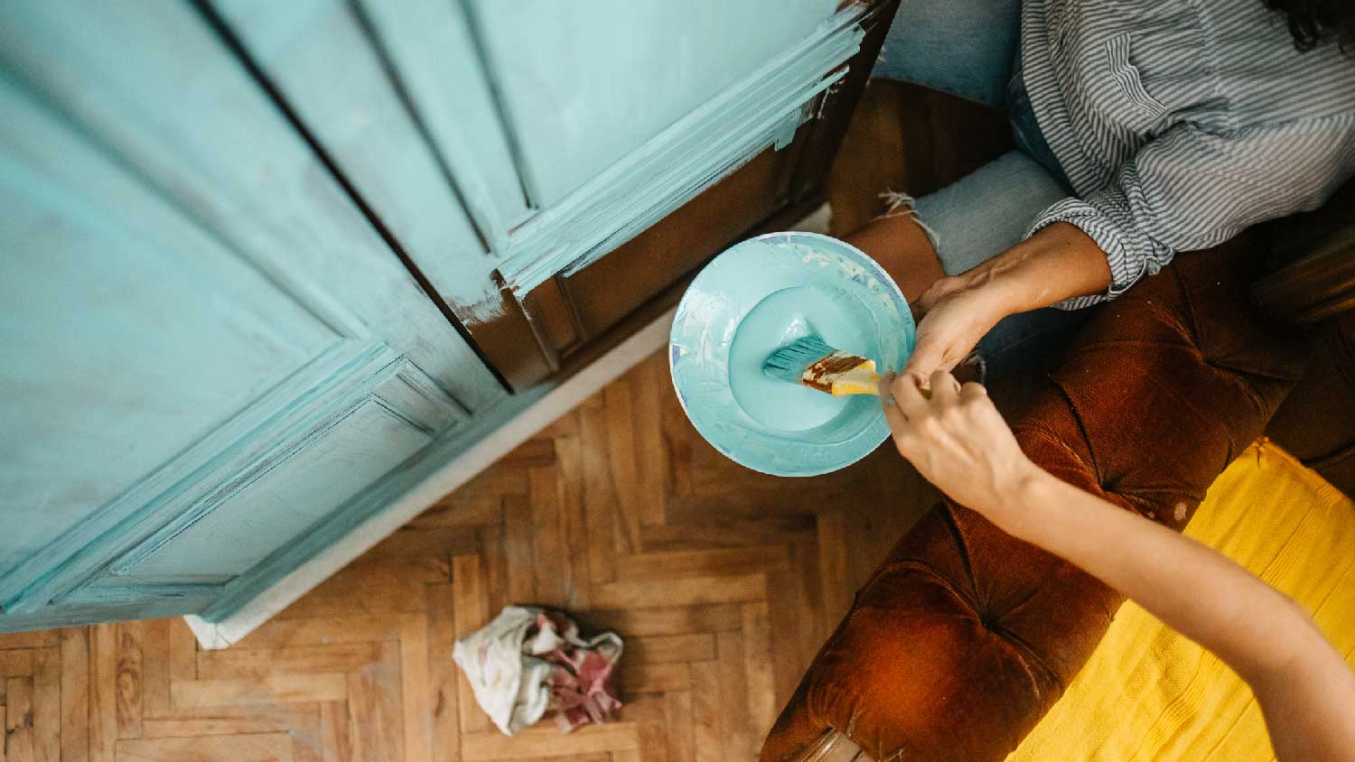 A couple painting a wall in soft blue