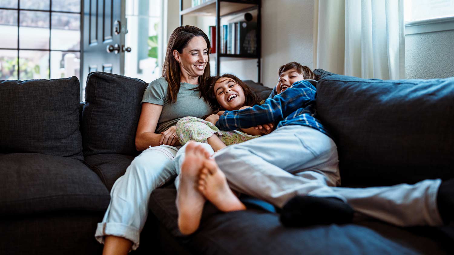 mother with kids hanging out on the couch