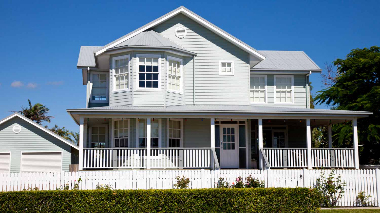 Colonial home with white picket fence