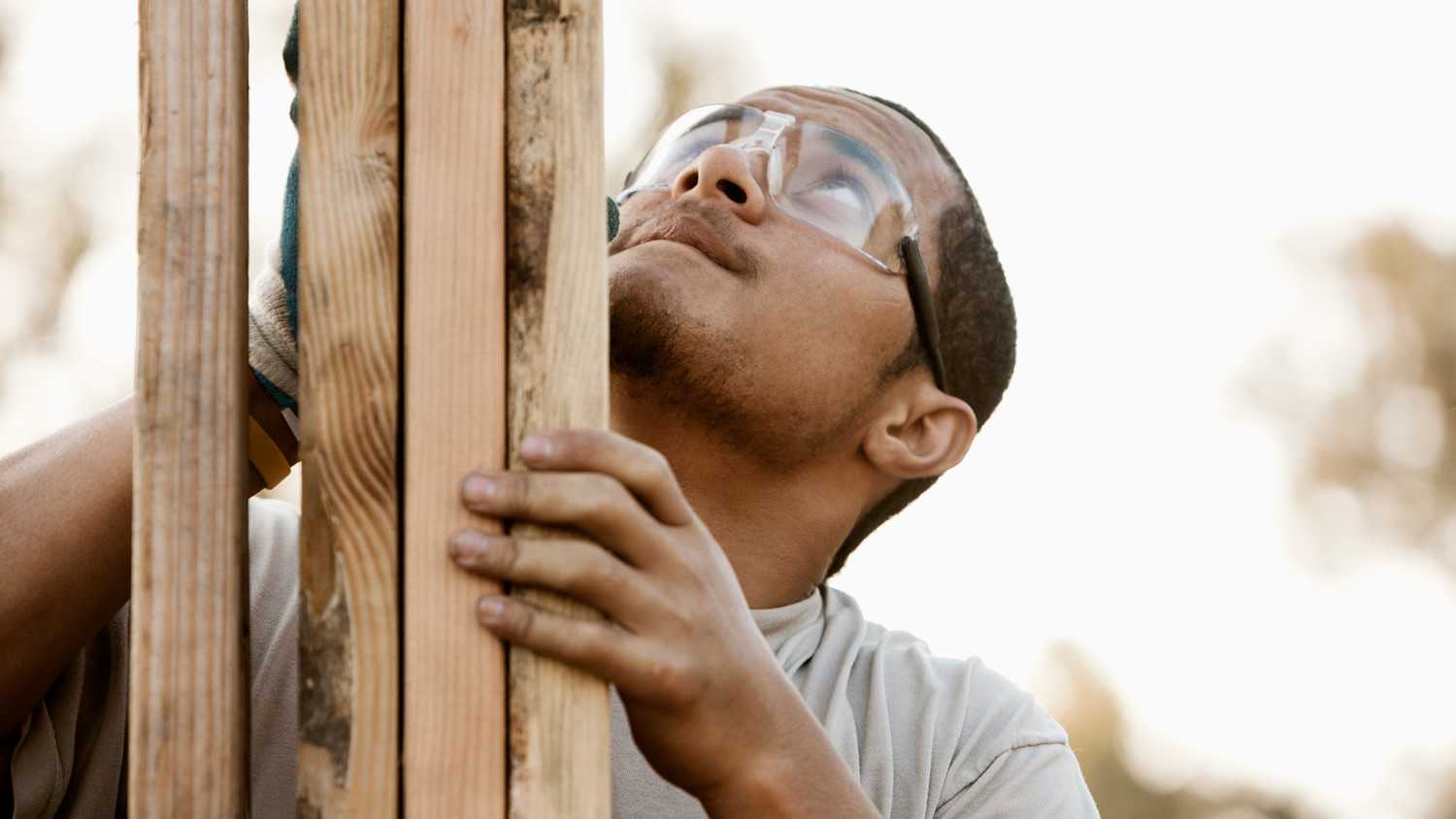 construction worker adjusting house frame