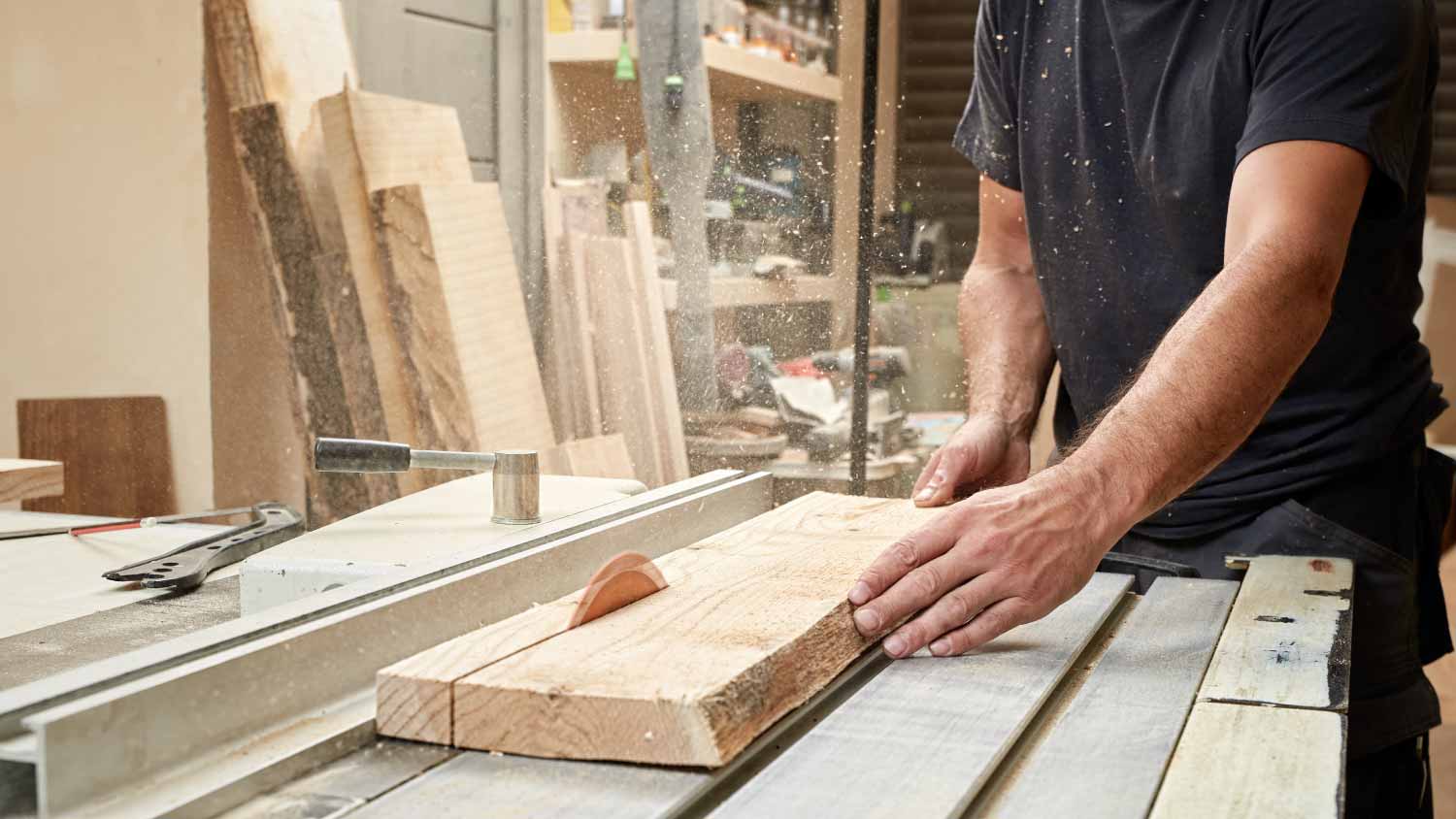 A carpenter working on a circular saw