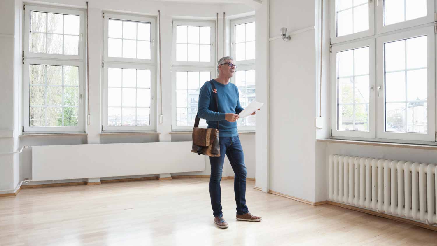 Man looking around in empty apartment