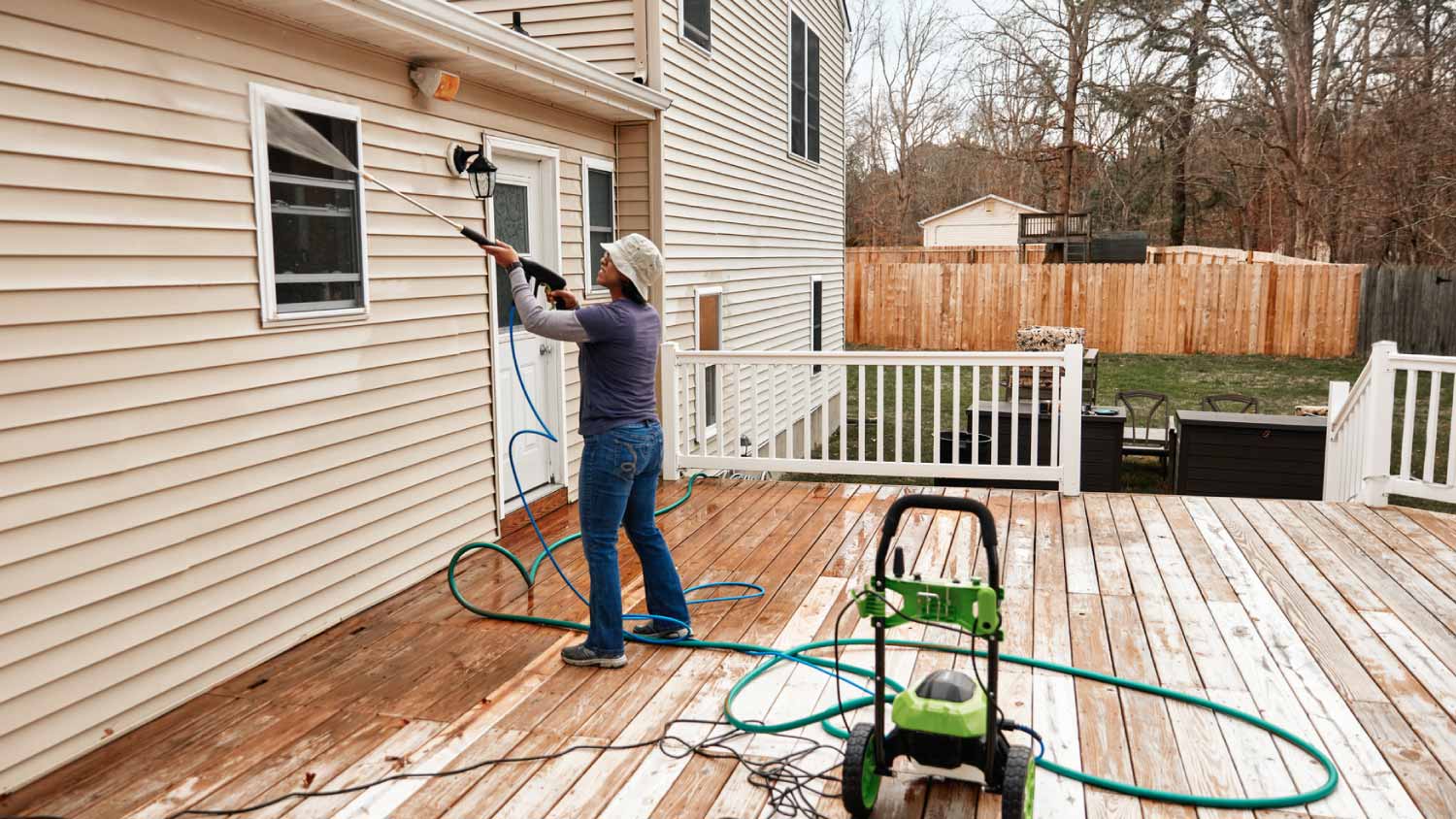 Woman cleaning wooden terrace