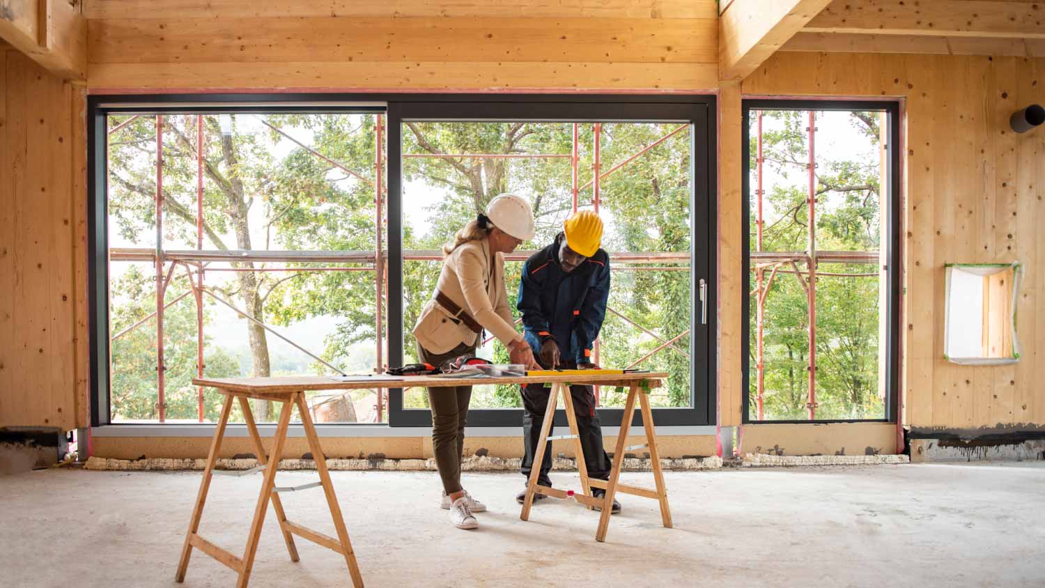 Architect and construction worker looking at plans