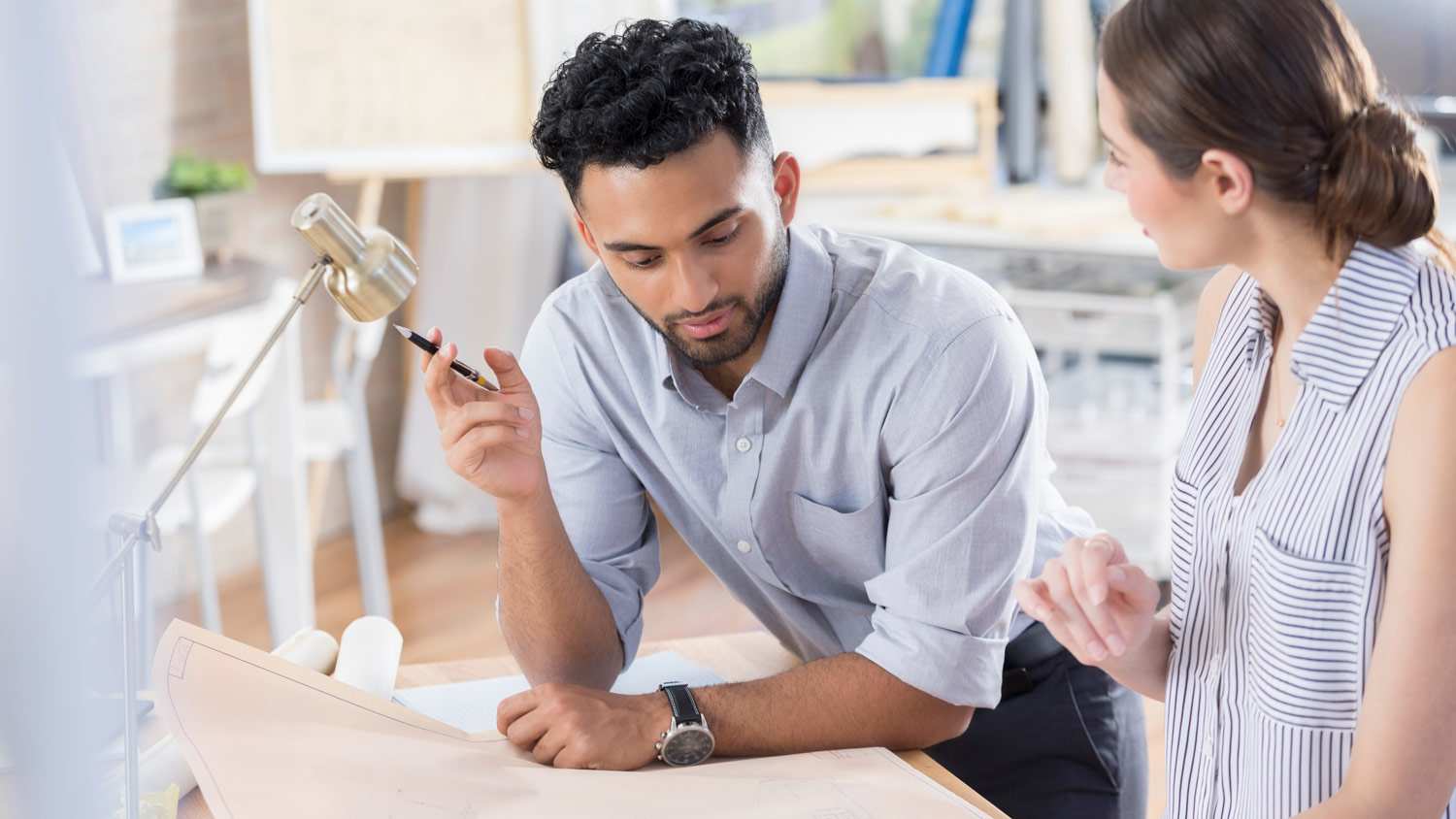 A contractor looking at blueprints with homeowner