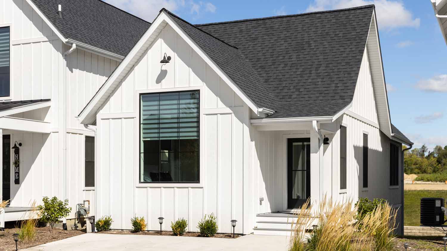 white farmhouse home with vertical siding