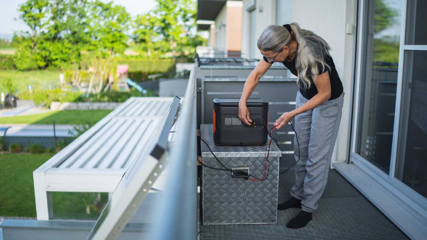 A woman operating a solar generator