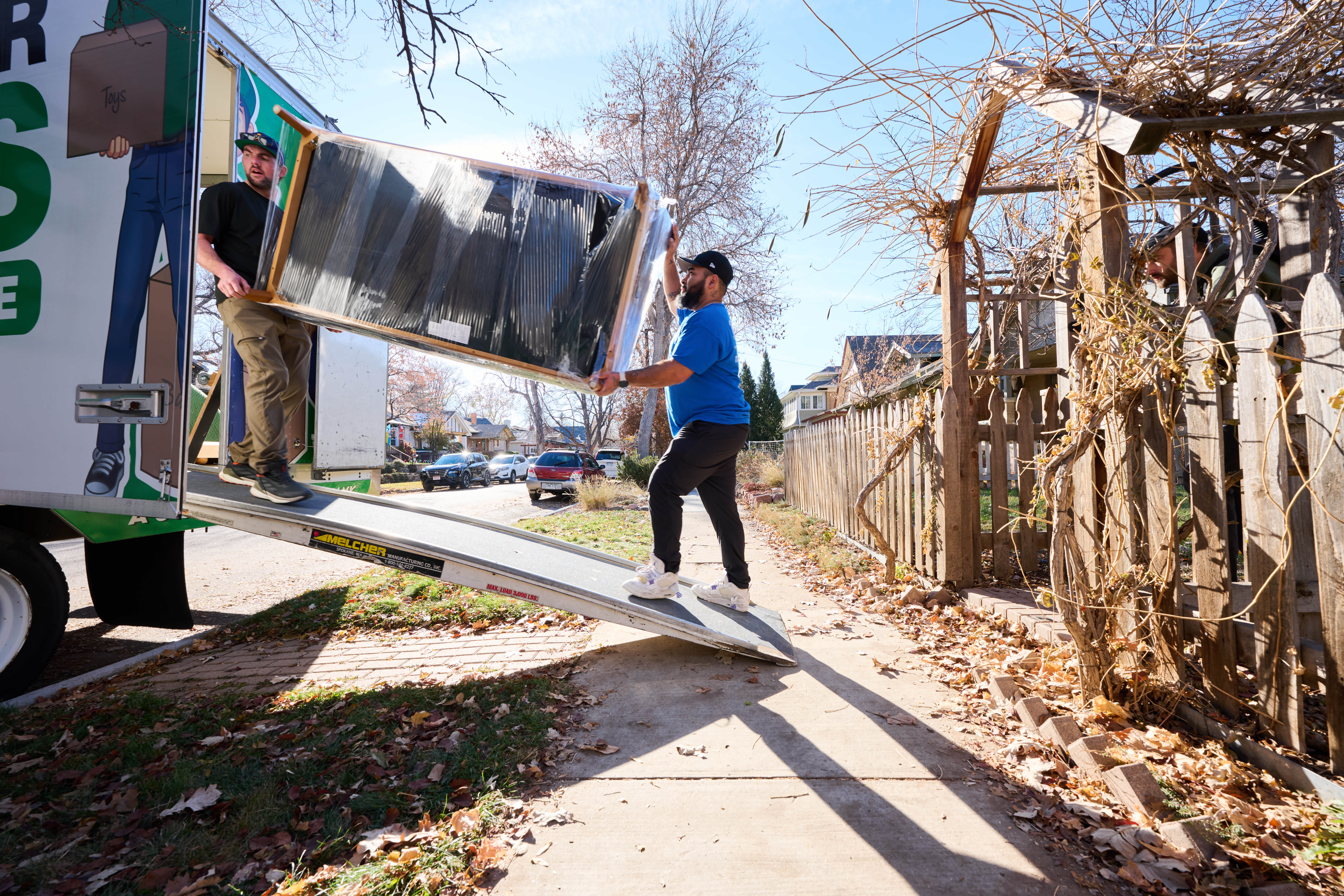 Men loading furniture into a moving truck.