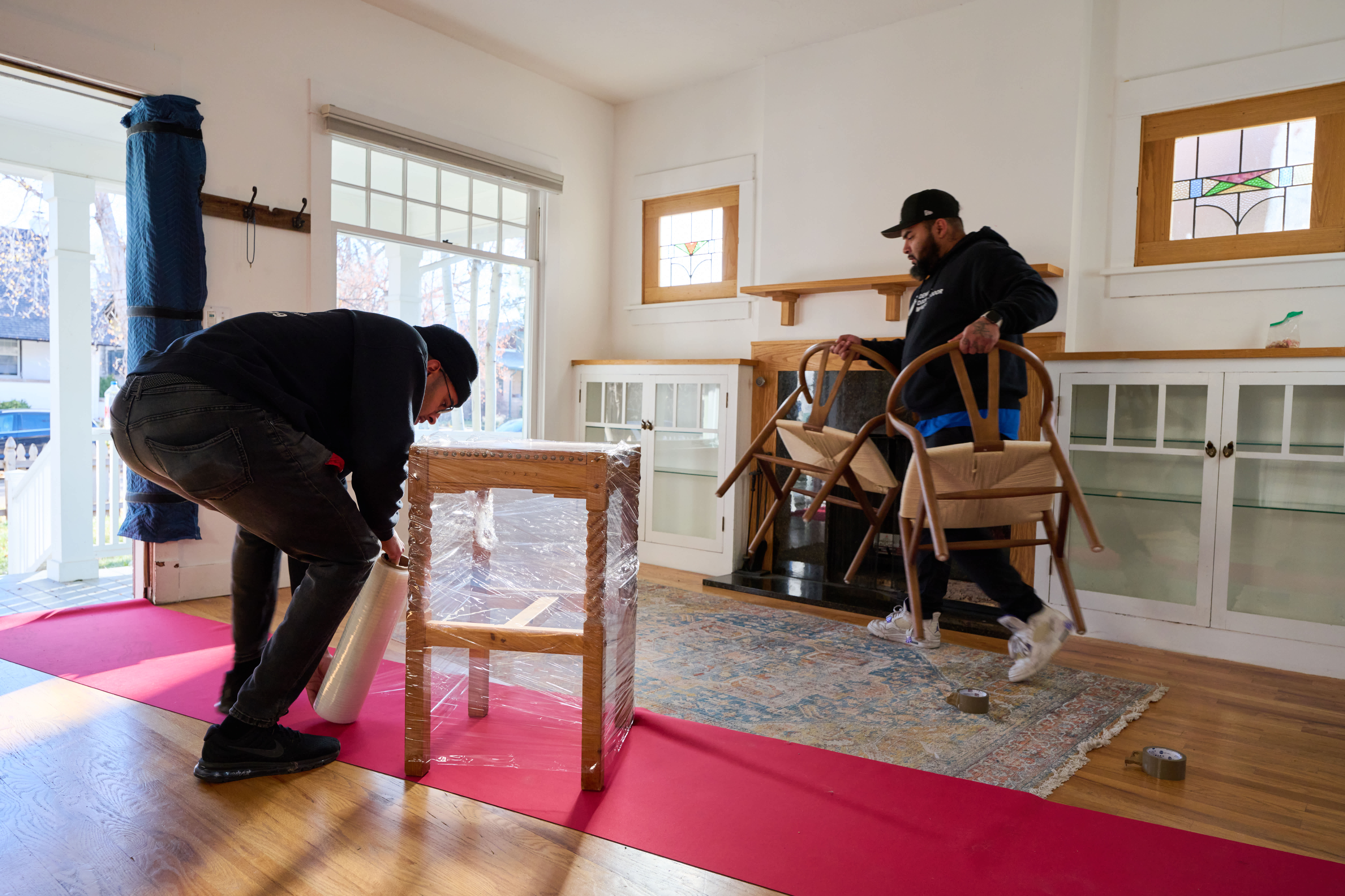 Two movers packing up house.