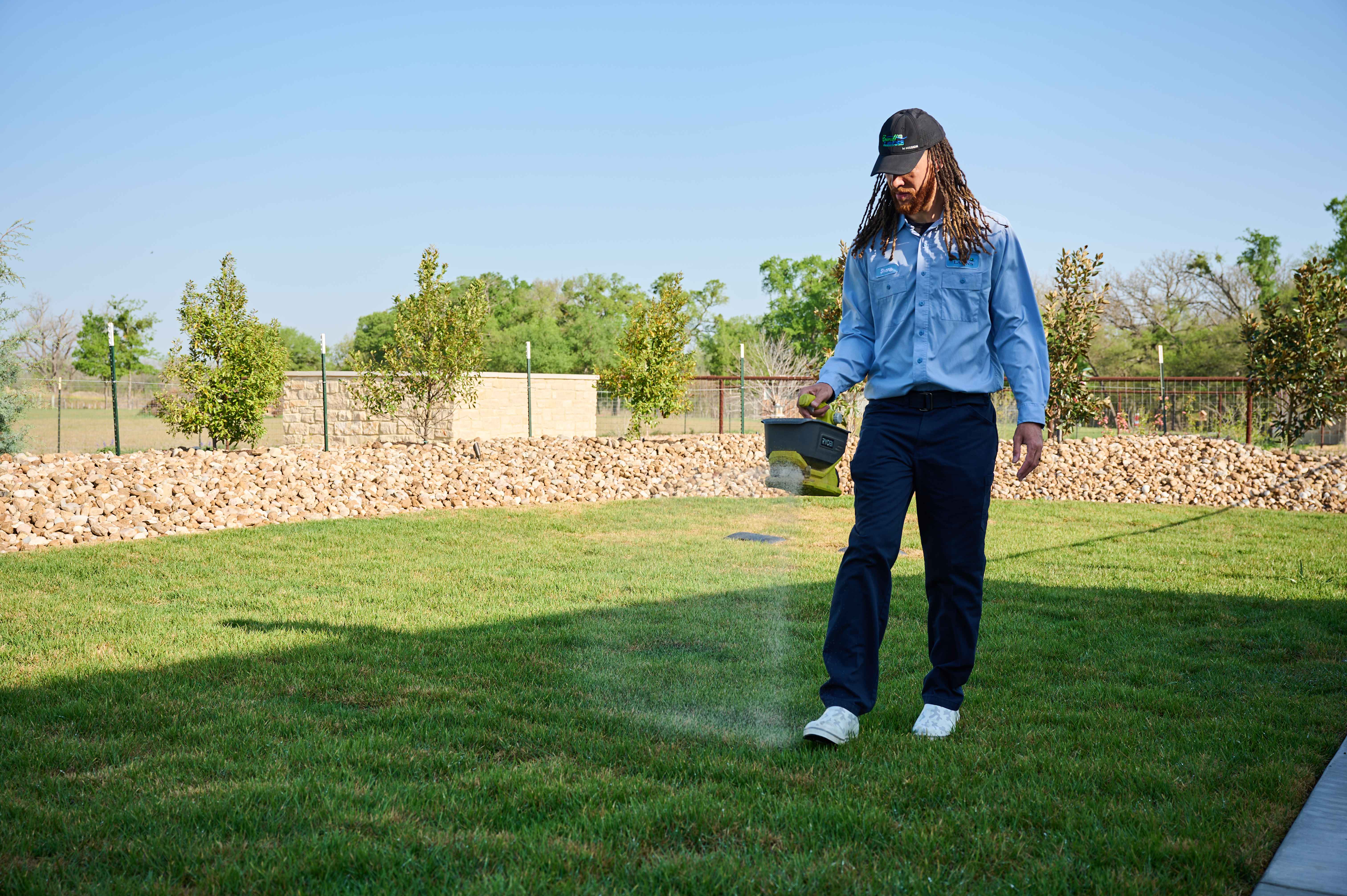 Man seeding fresh lawn.