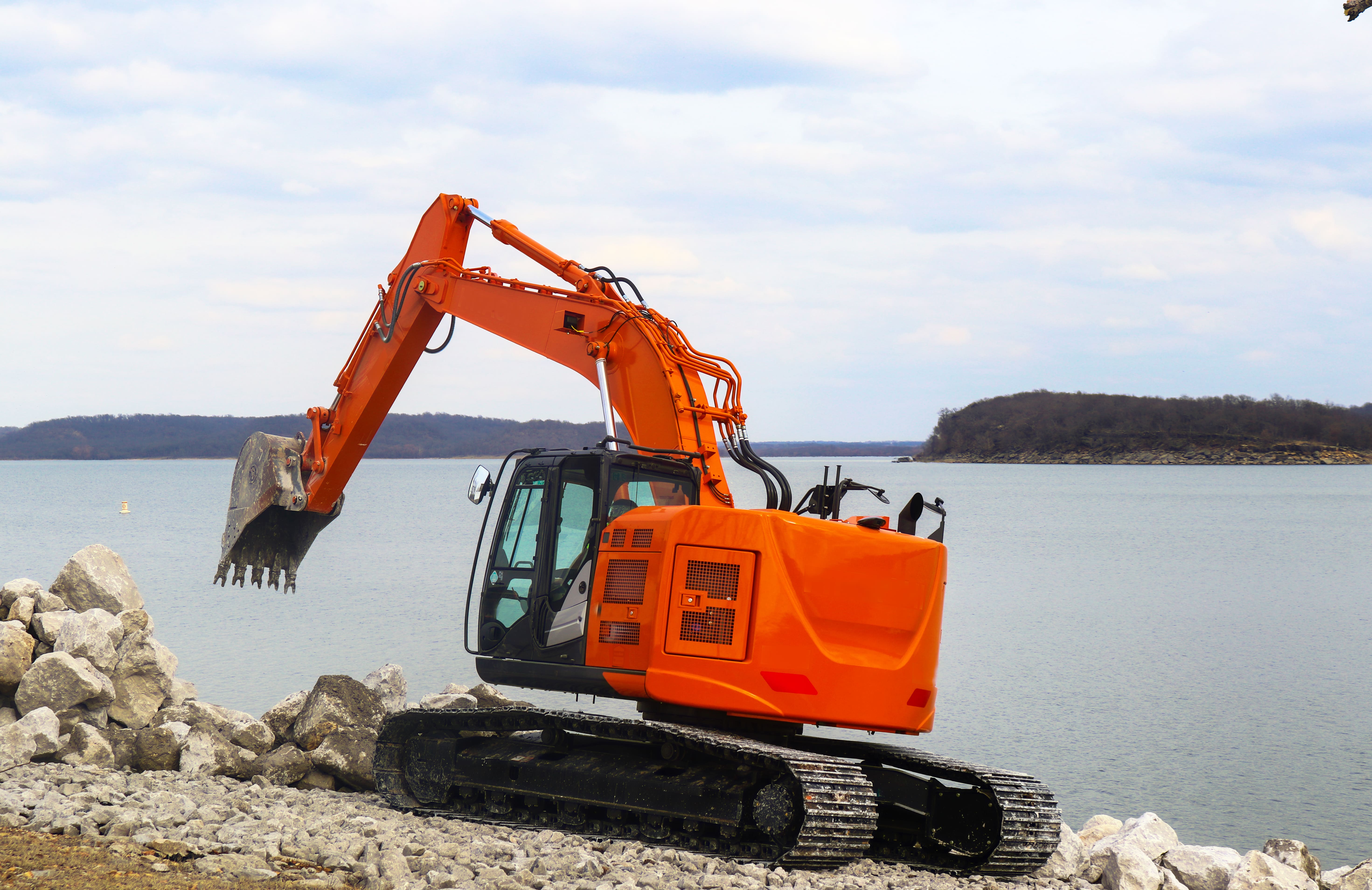 Waterfront contractor installing rip rap along the bay