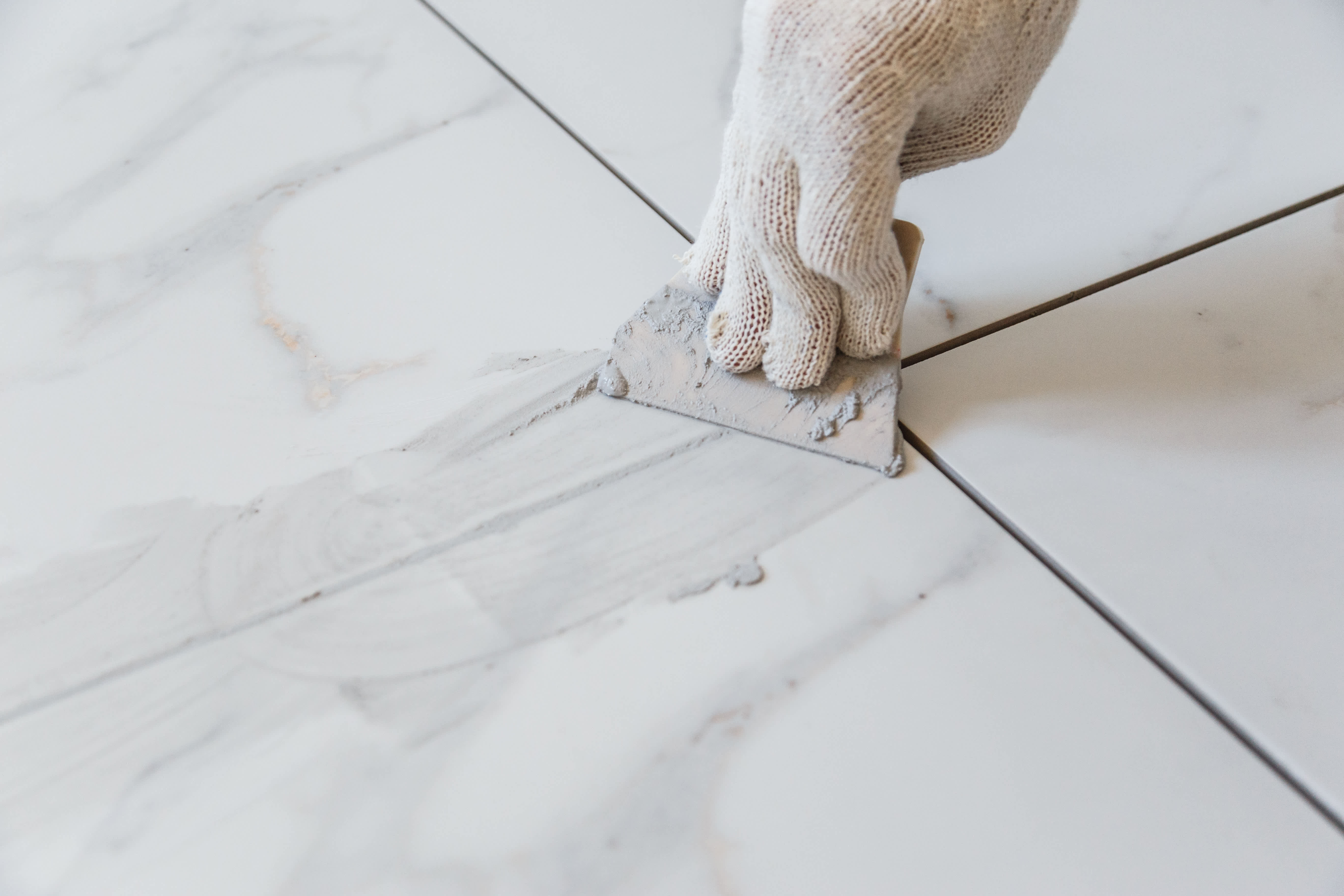 Woman grouting tiles