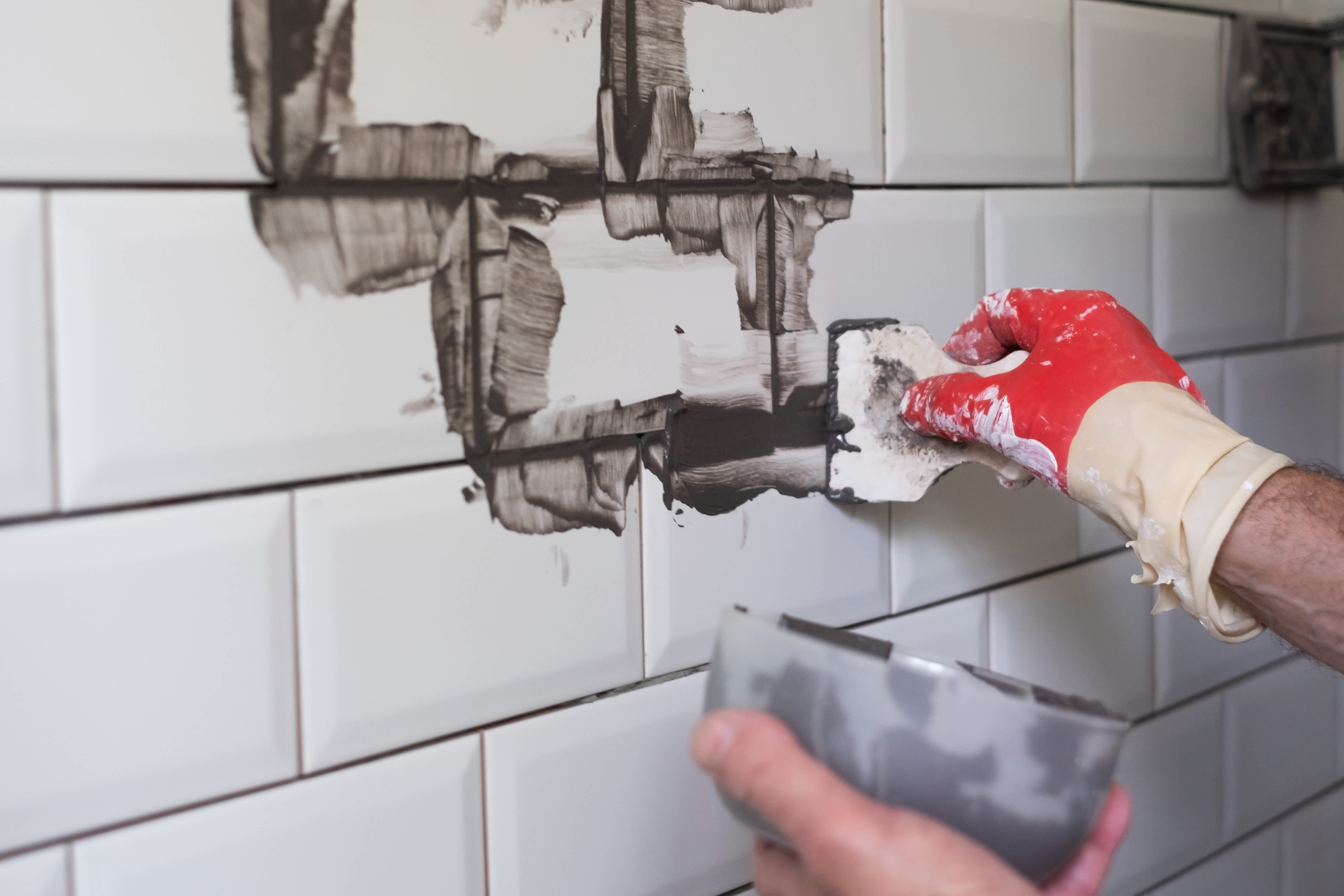 Worker grouting tiles
