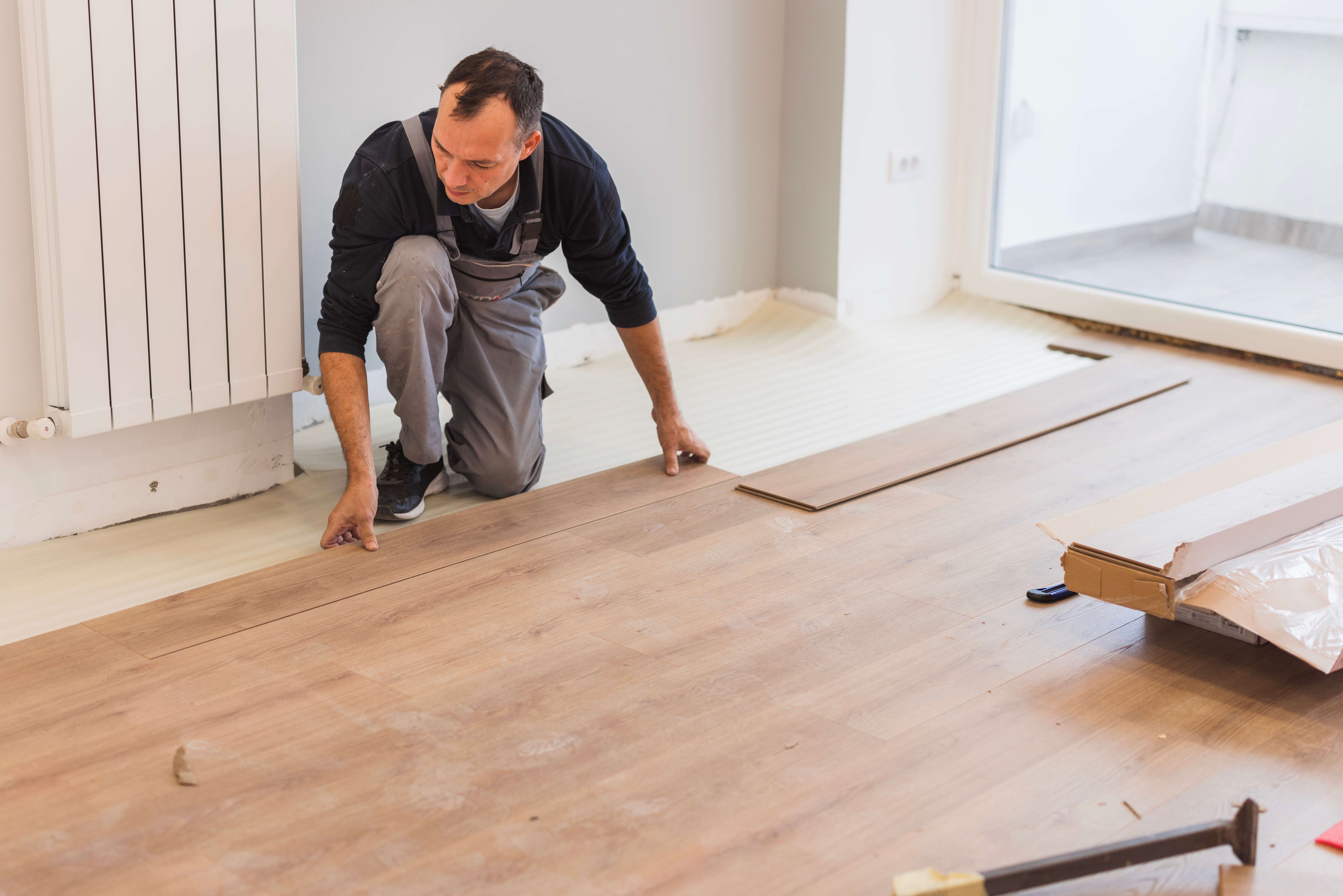 Carpenter adjusting hardwood floor