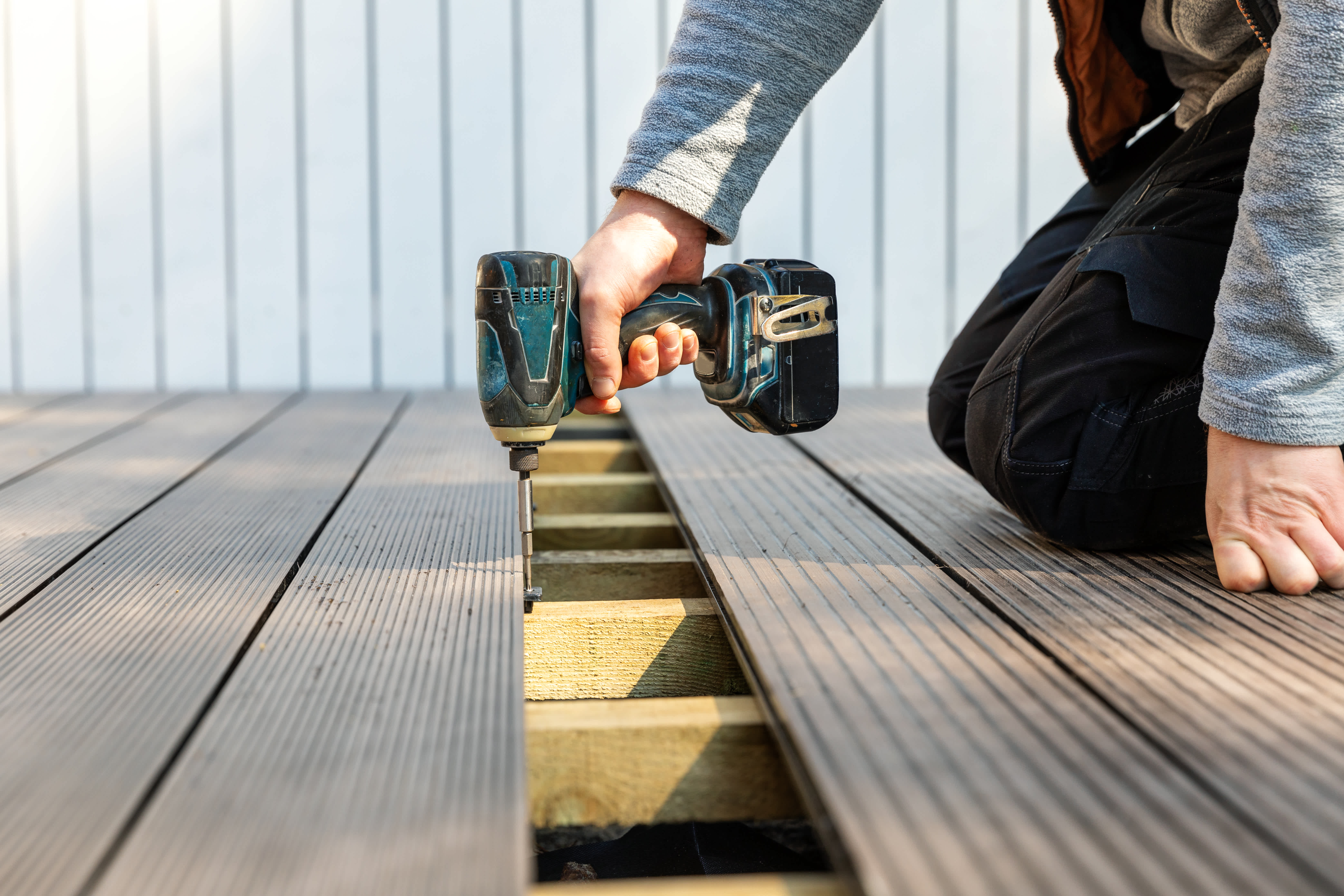 Handyperson replacing old deck boards