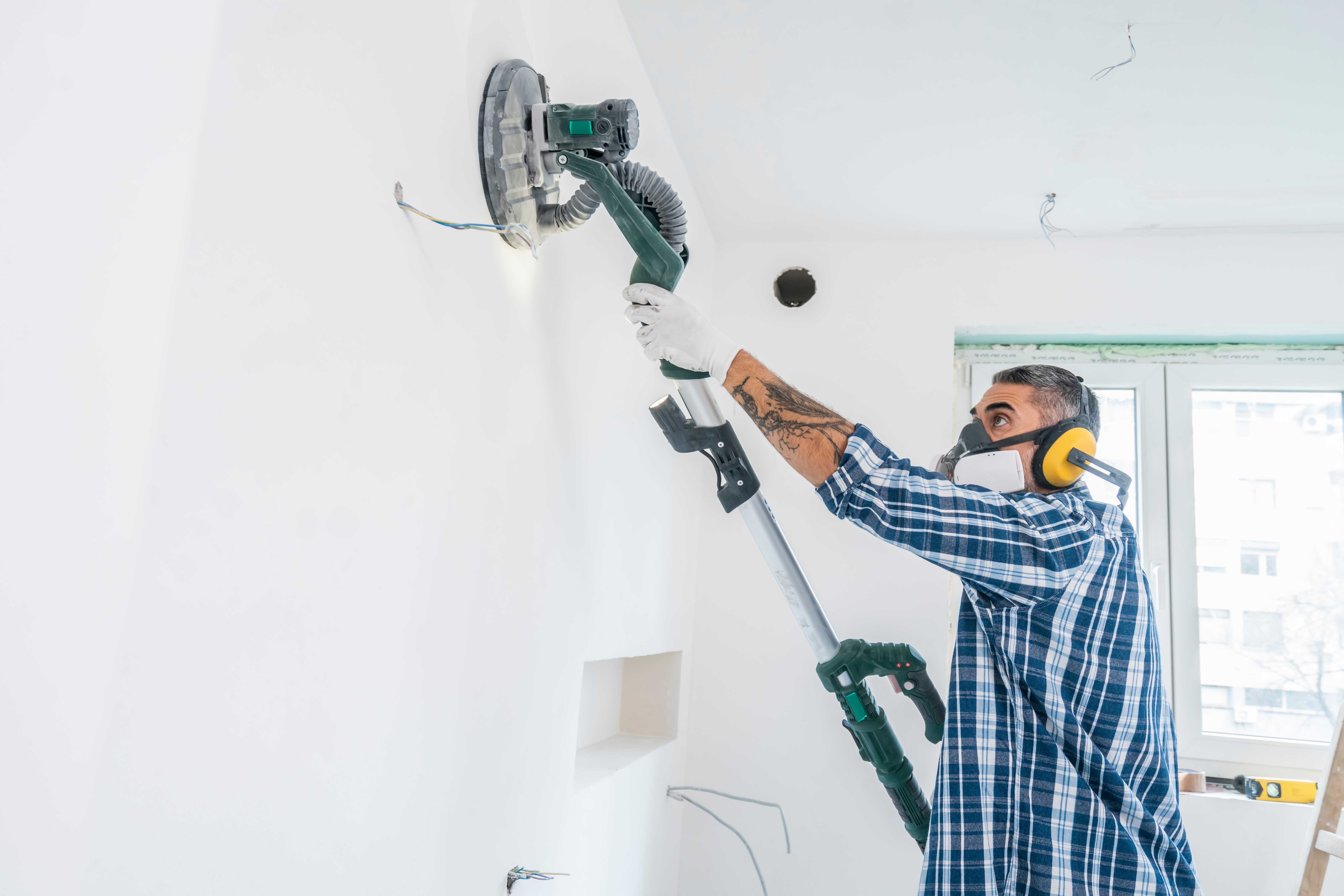 Man using vacuum sanding machine