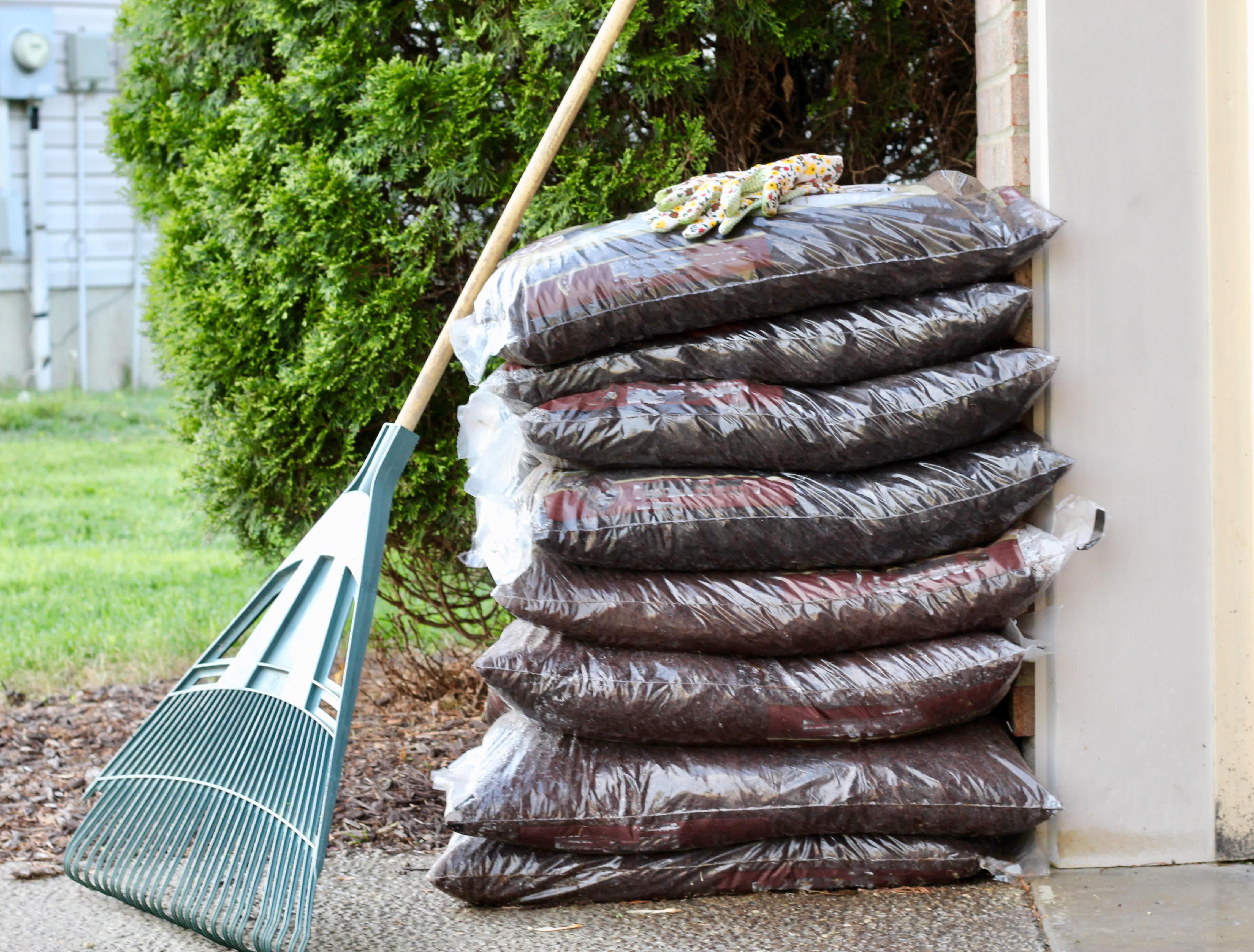 Bags of mulch stacked in the yard