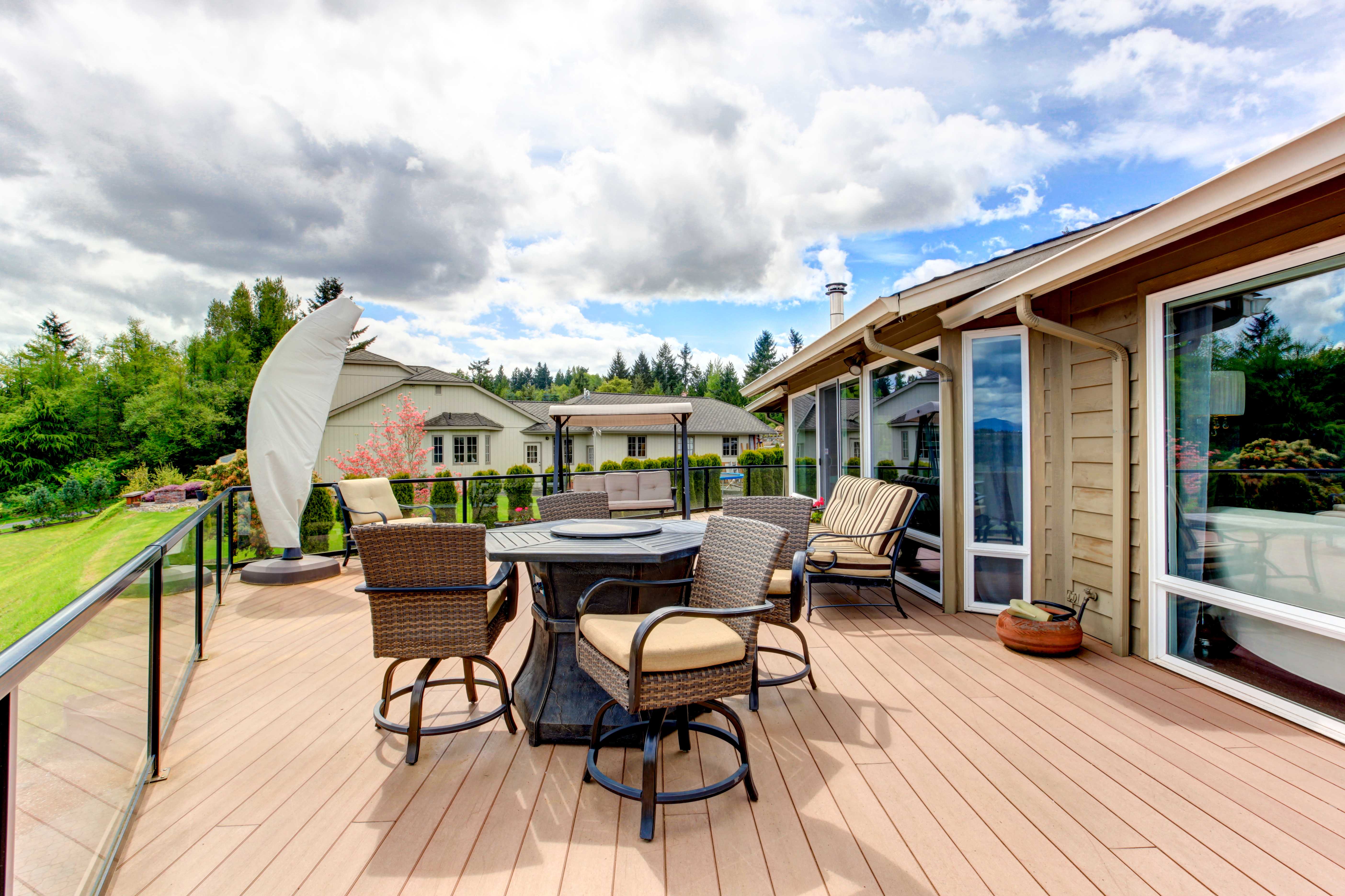 Large walkout deck with stained decking and patio furniture