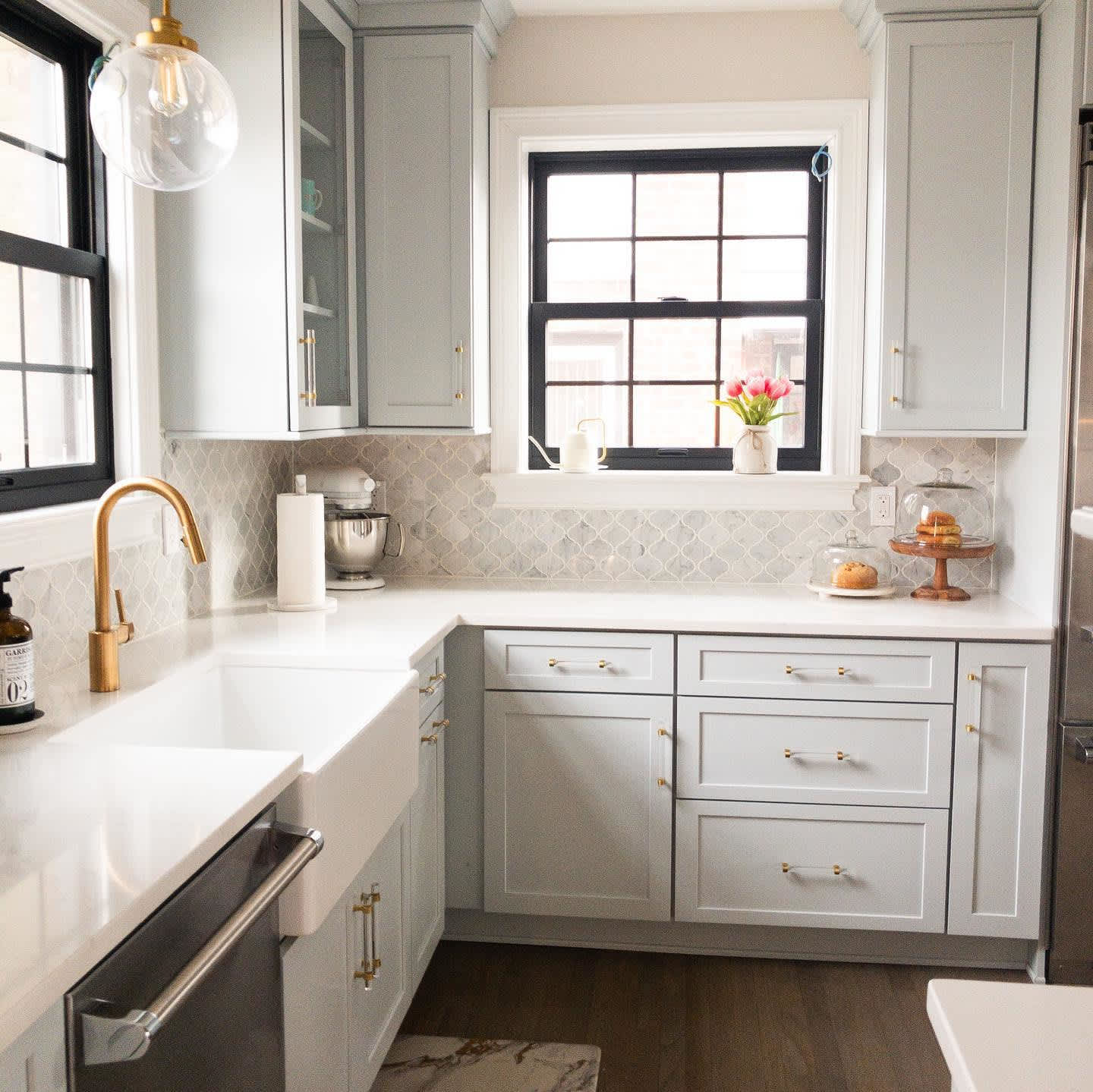 Light-colored kitchen with gold hardware in Portland, OR