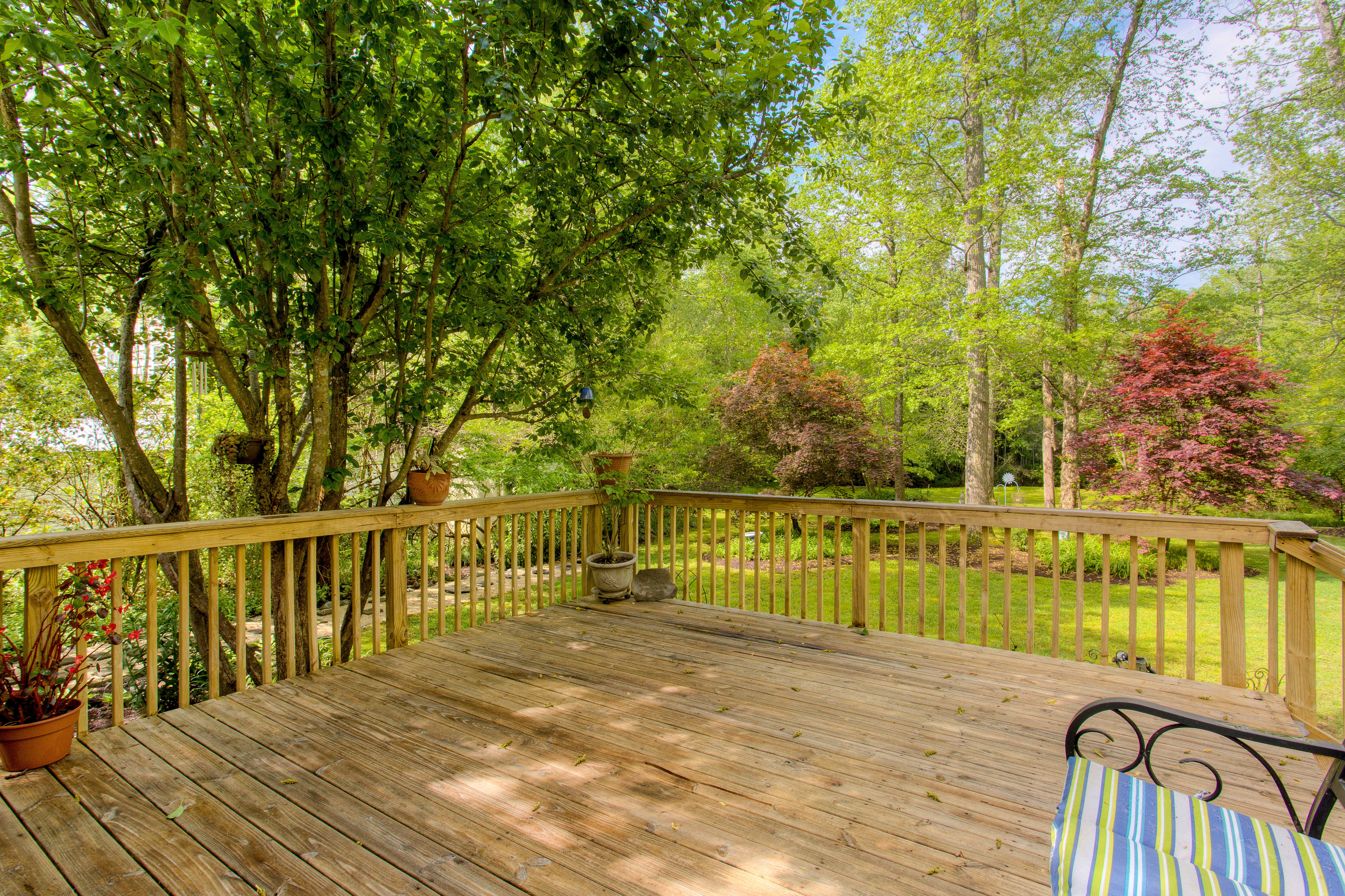 A wooden deck in the backyard during summer