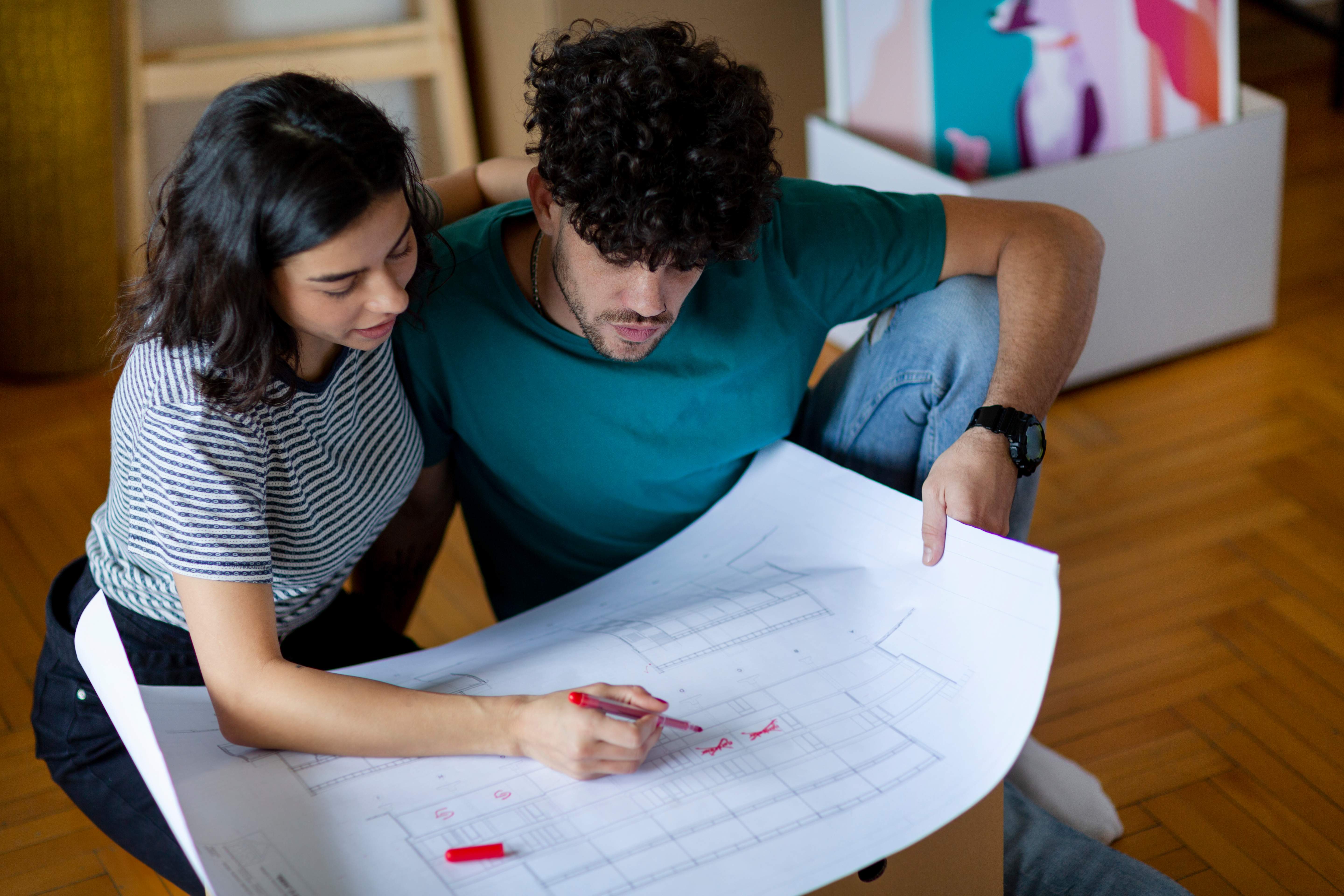 A couple looking at the blueprints of their home