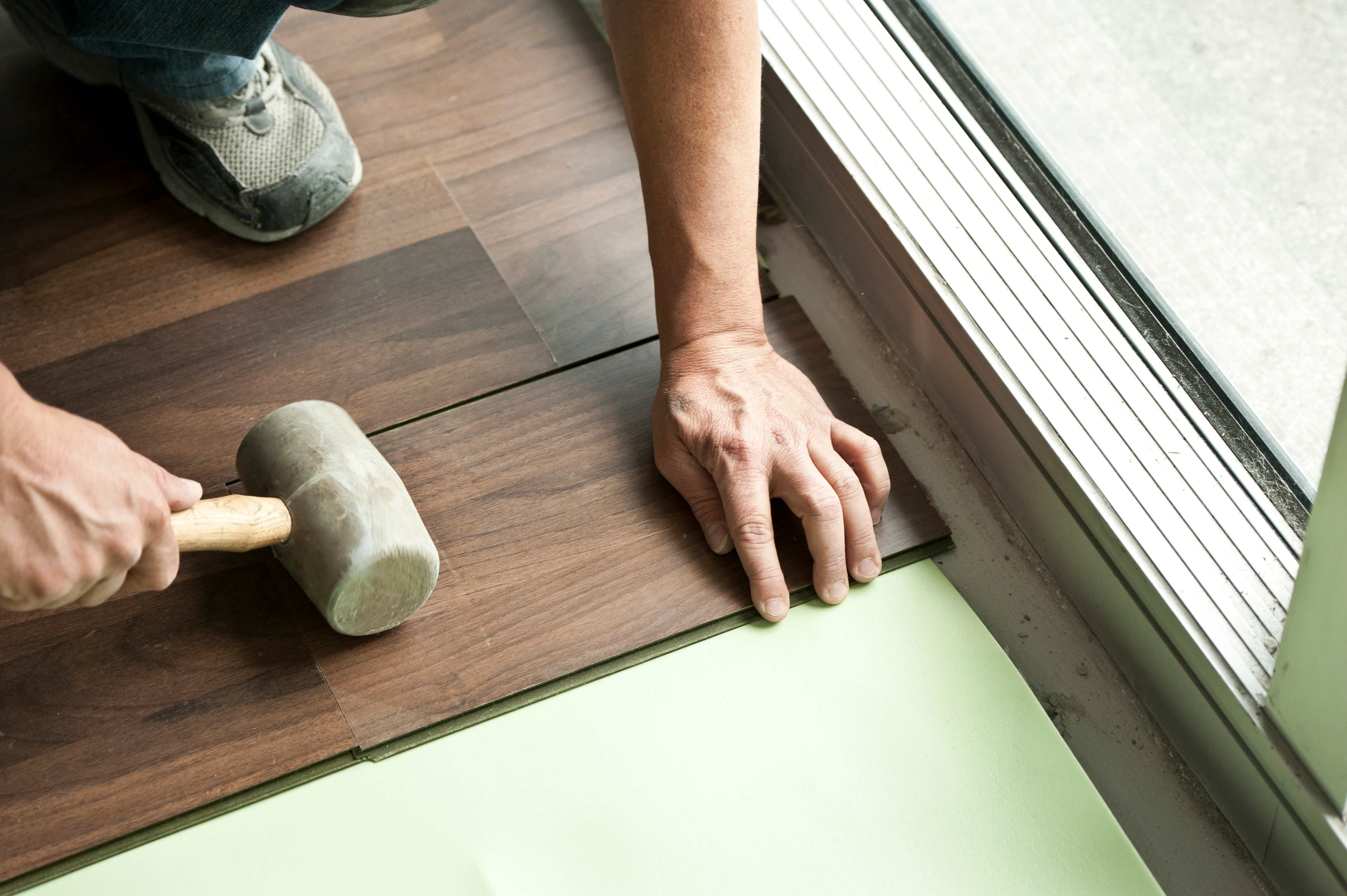Man holding installing vinyl floor
