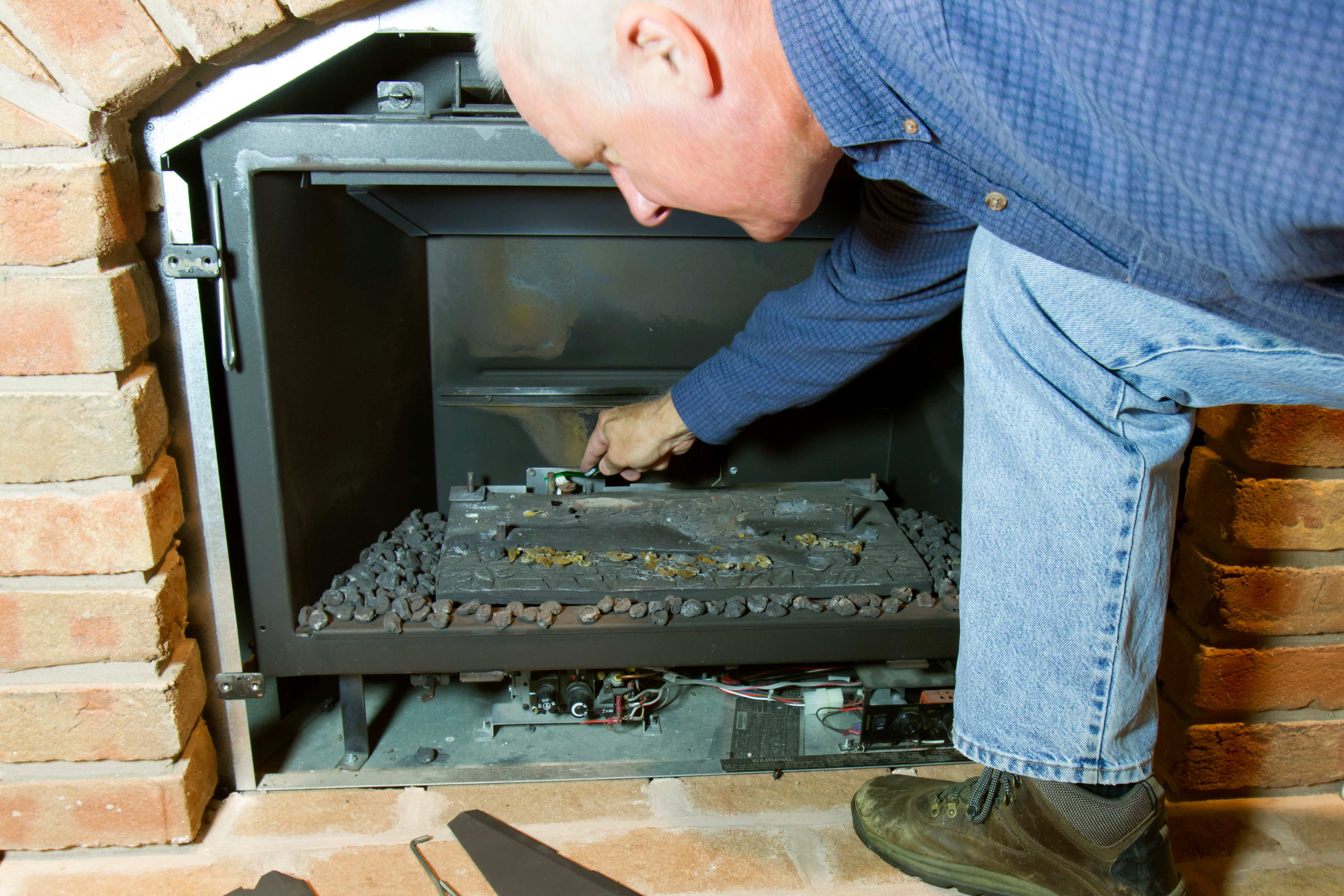 Worker checking out gas fireplace