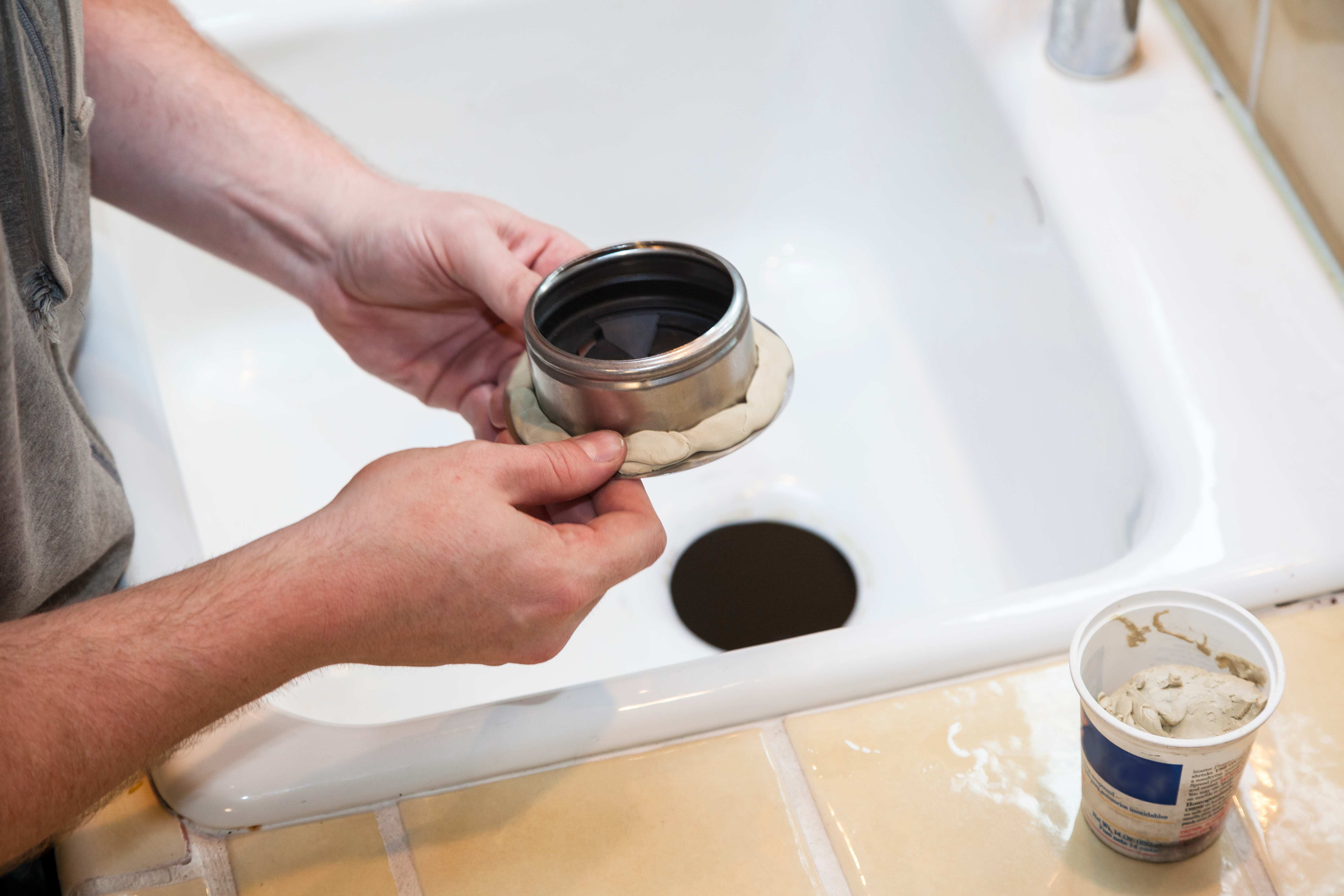Man installing garbage disposal
