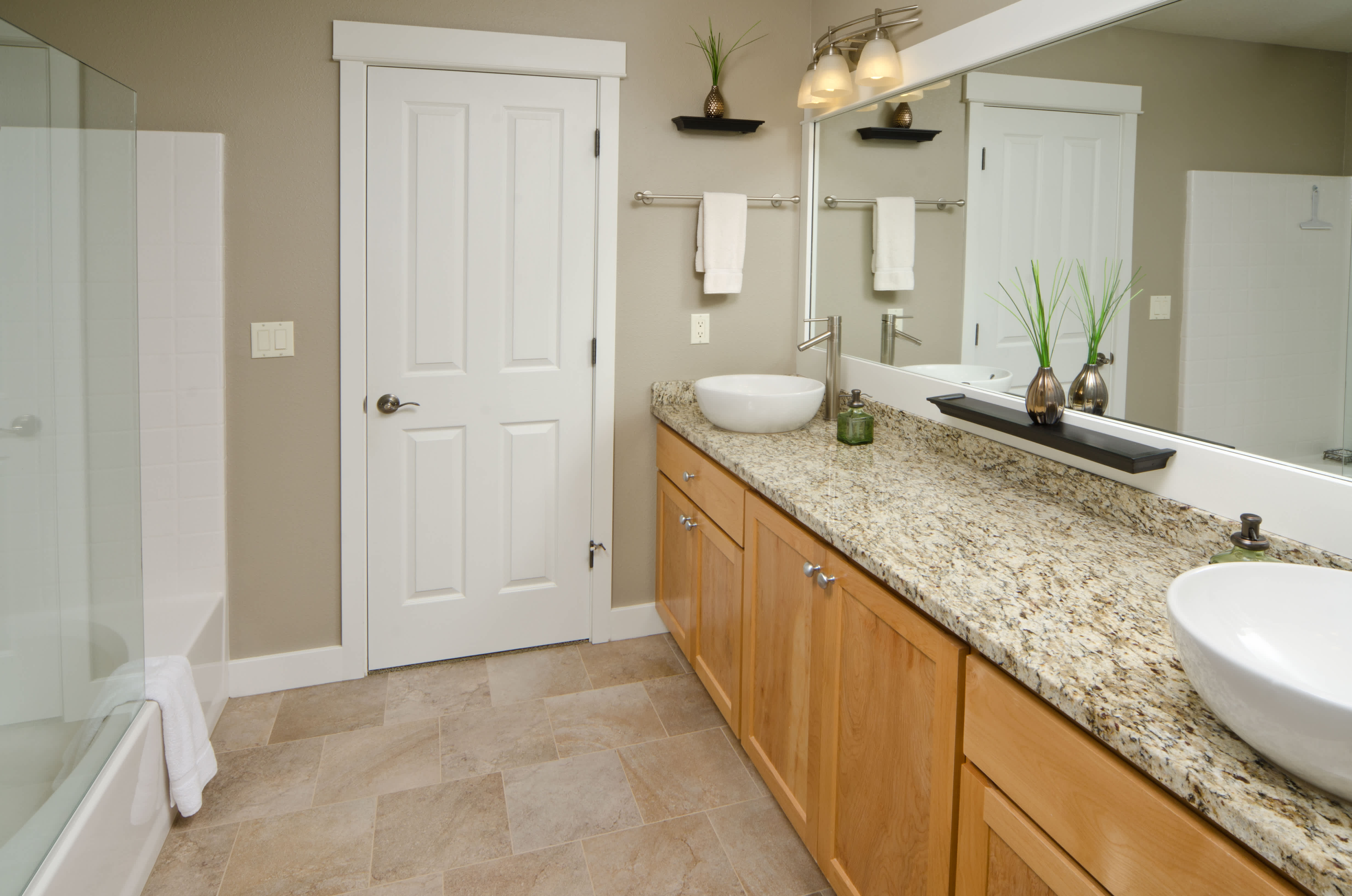 White PVC baseboard installed in a bathroom with beige walls