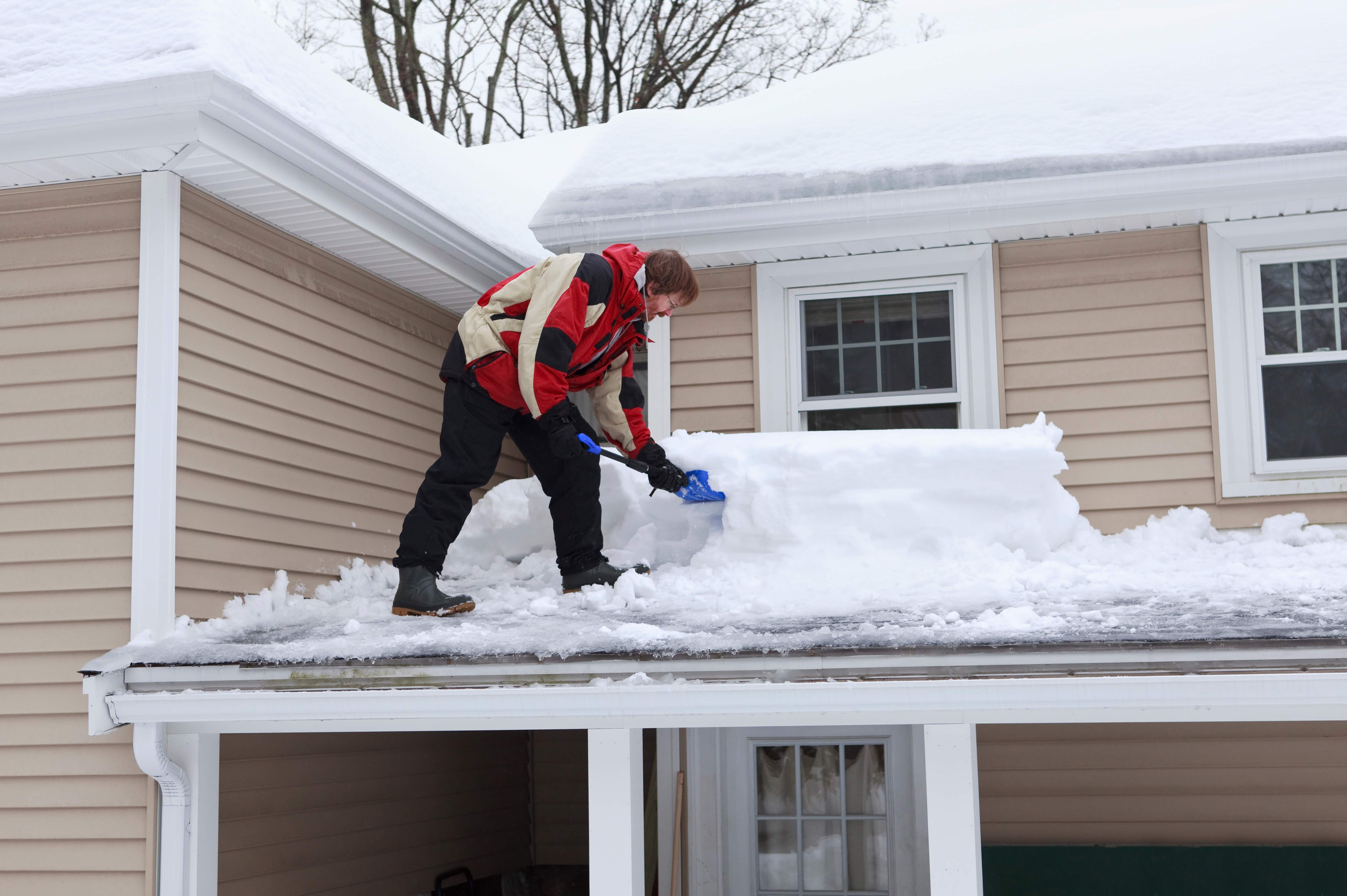 Man shoveling roof