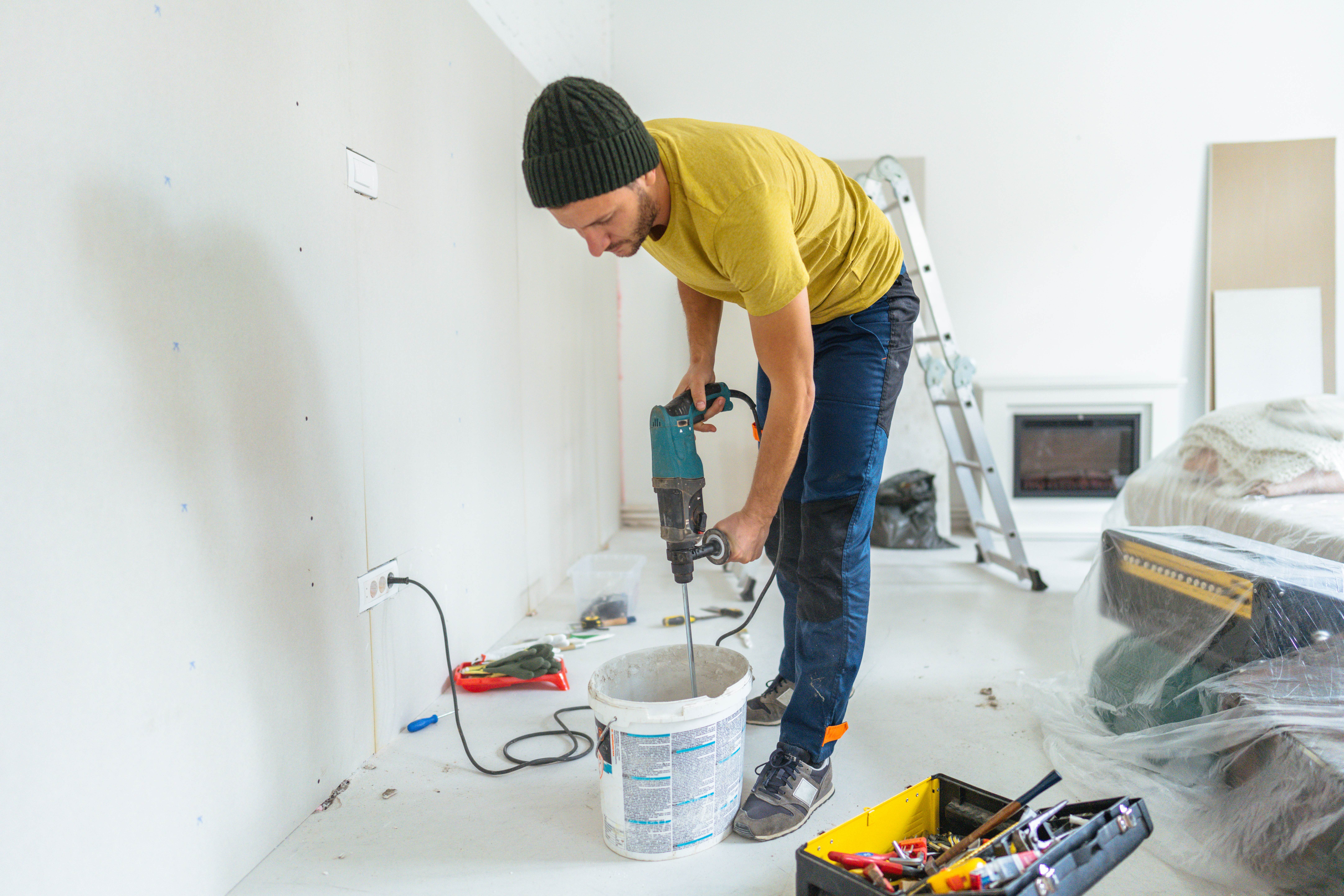 A professional mixing drywall mud
