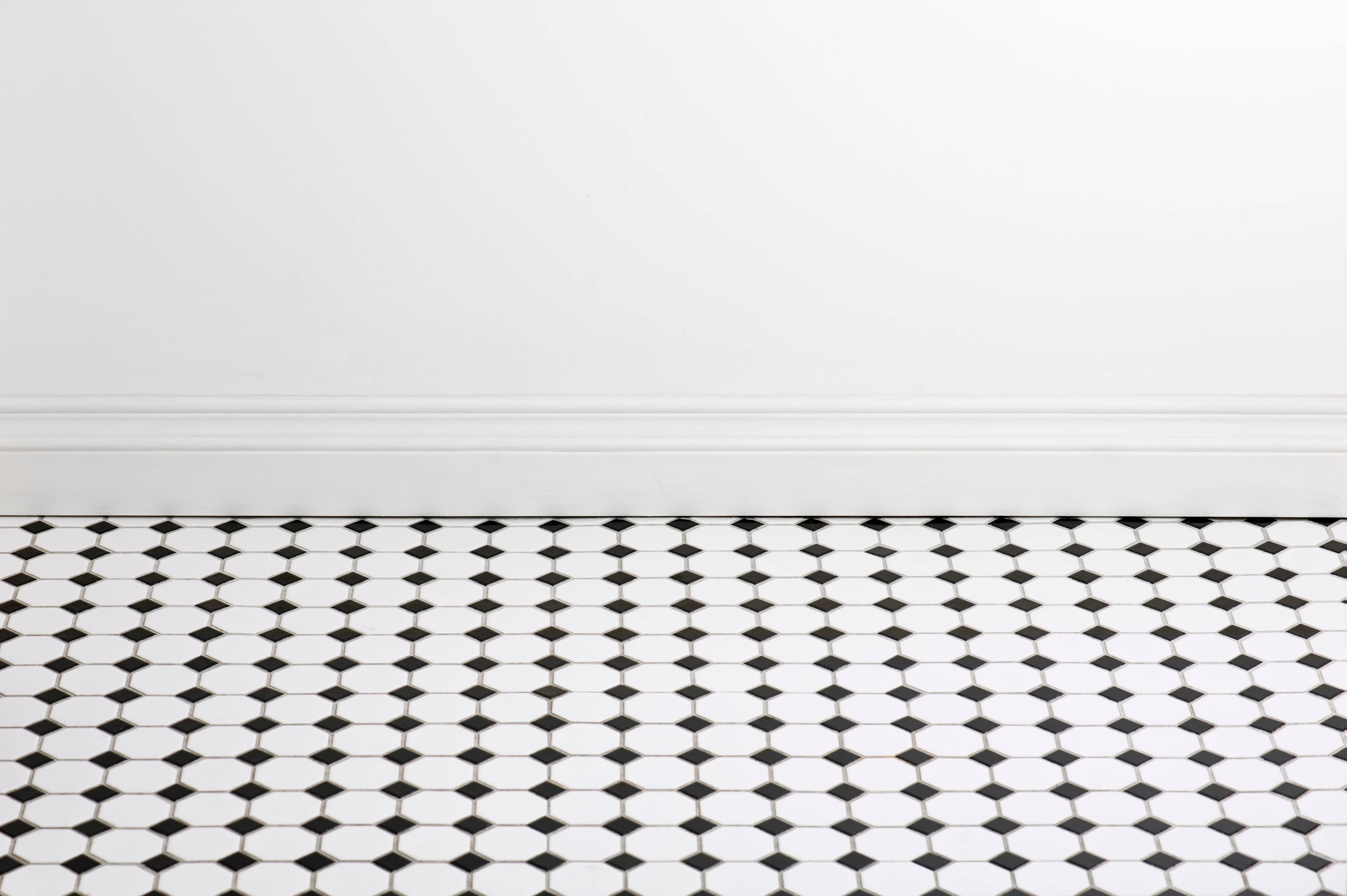 Bathroom with tile flooring and empty white wall