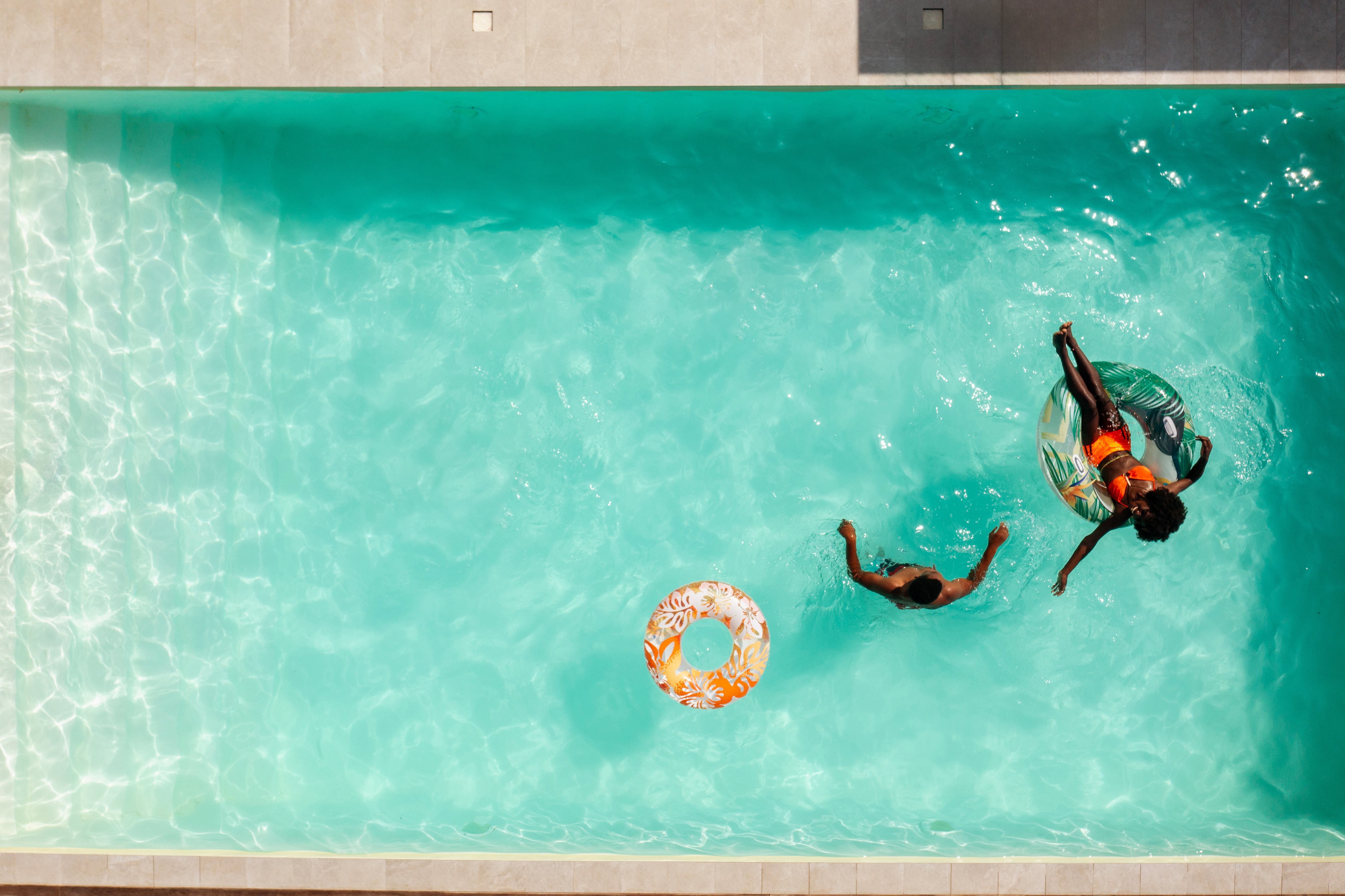 Couple relaxing in a swimming pool with a white liner