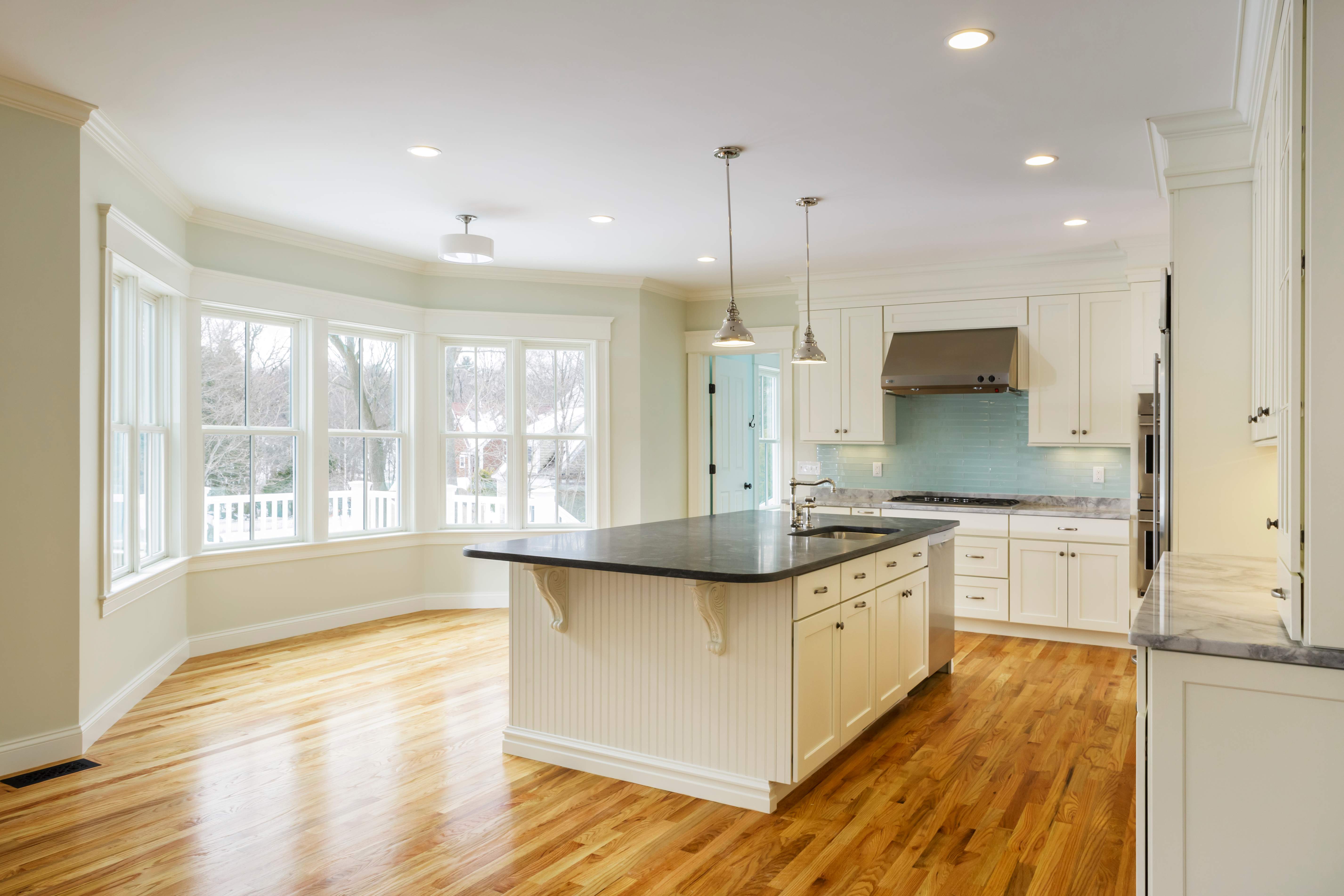 A spacious kitchen with hardwood floor