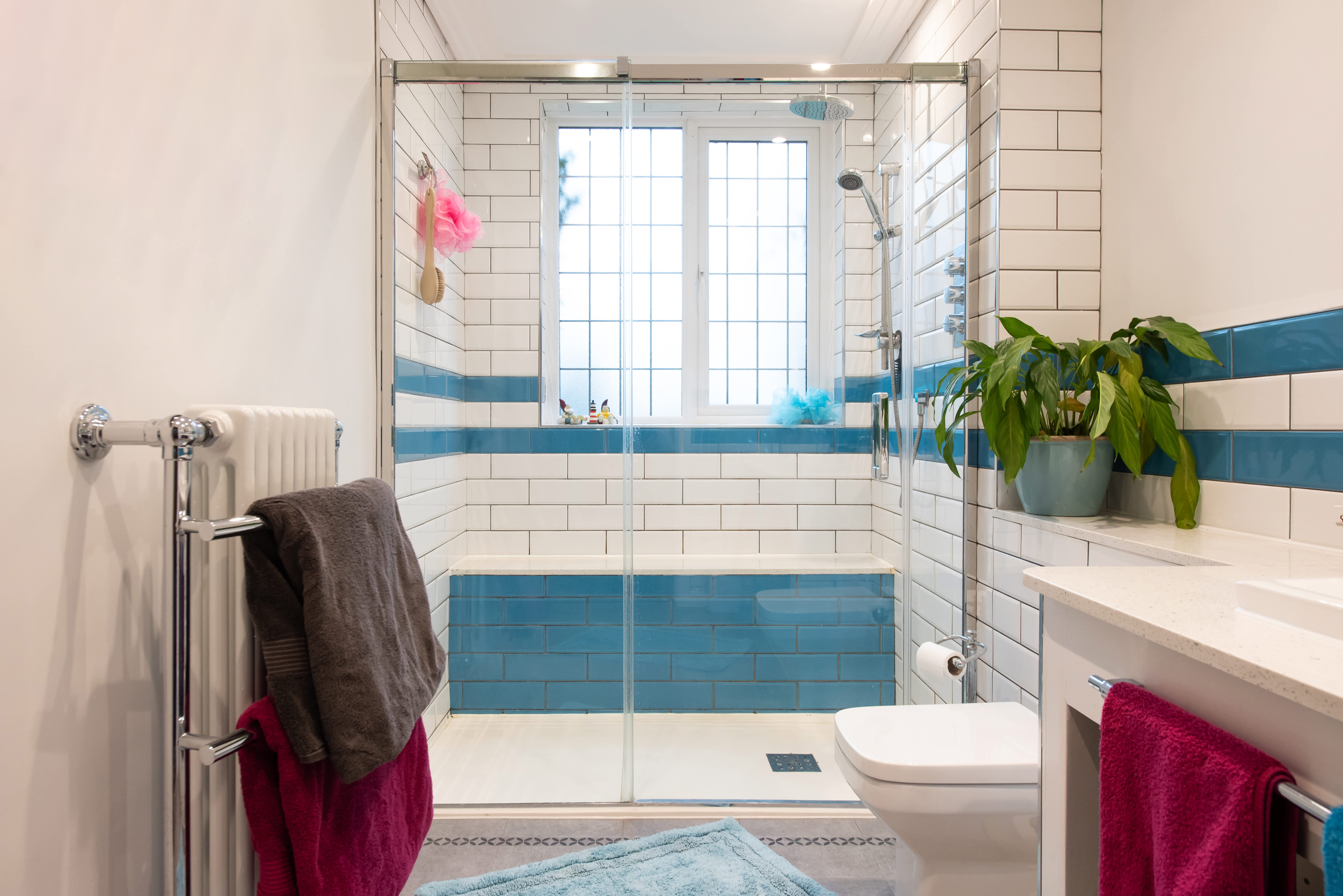 A general interior view of a white and blue tiled bathroom