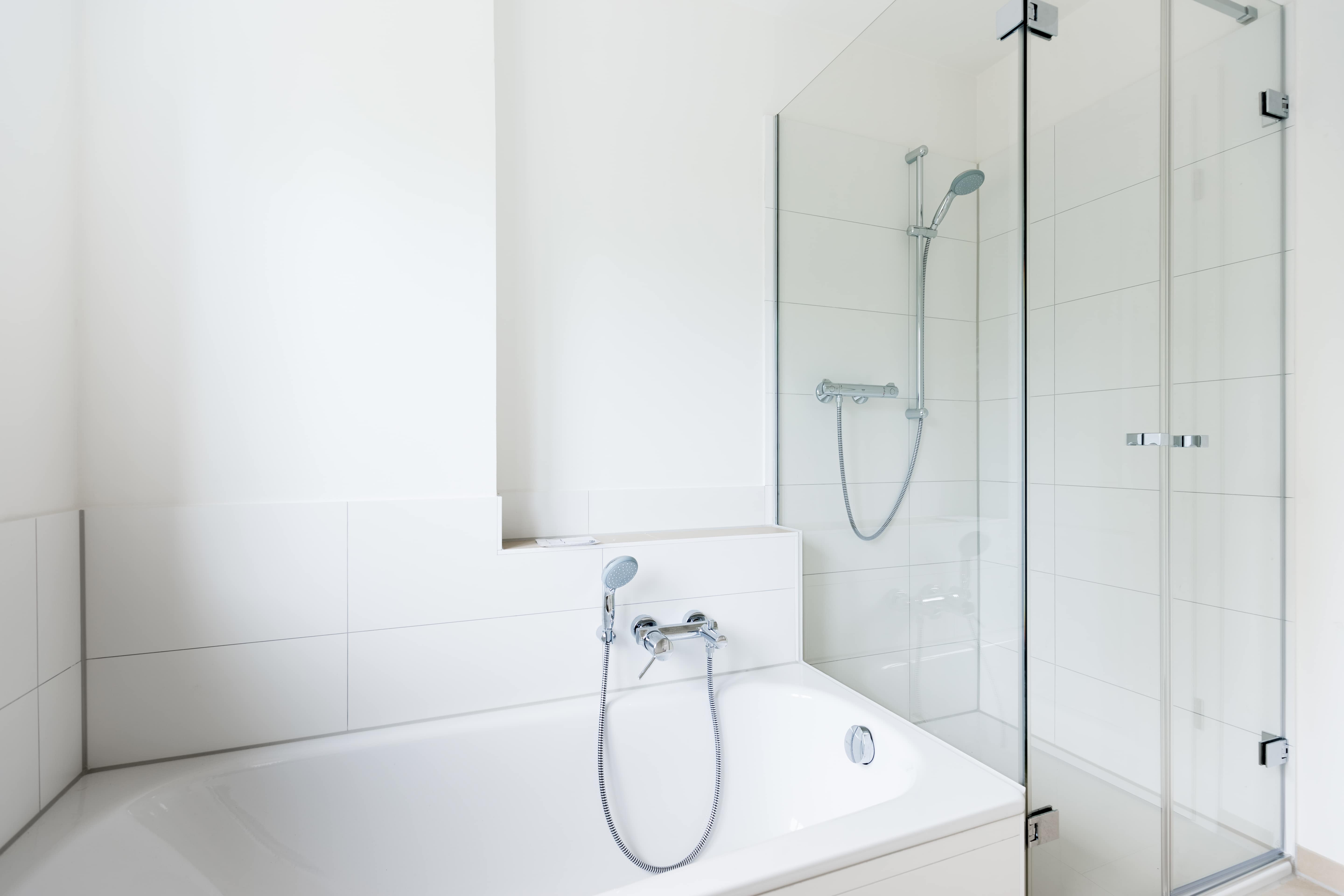 Modern white bathroom with shower and bathtub