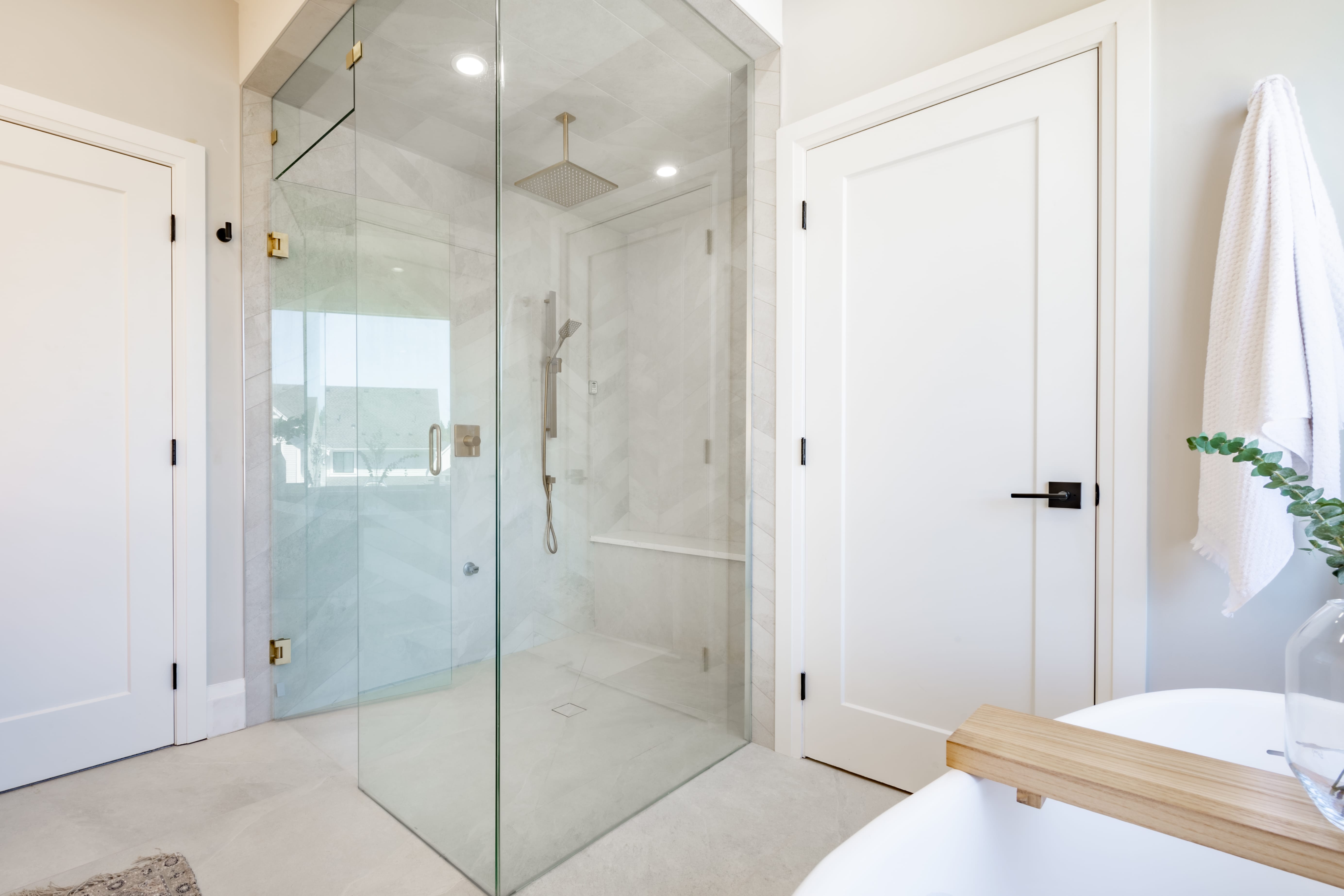 Elegant bathroom glass wall shower with black faucet fixtures and a small round black sink
