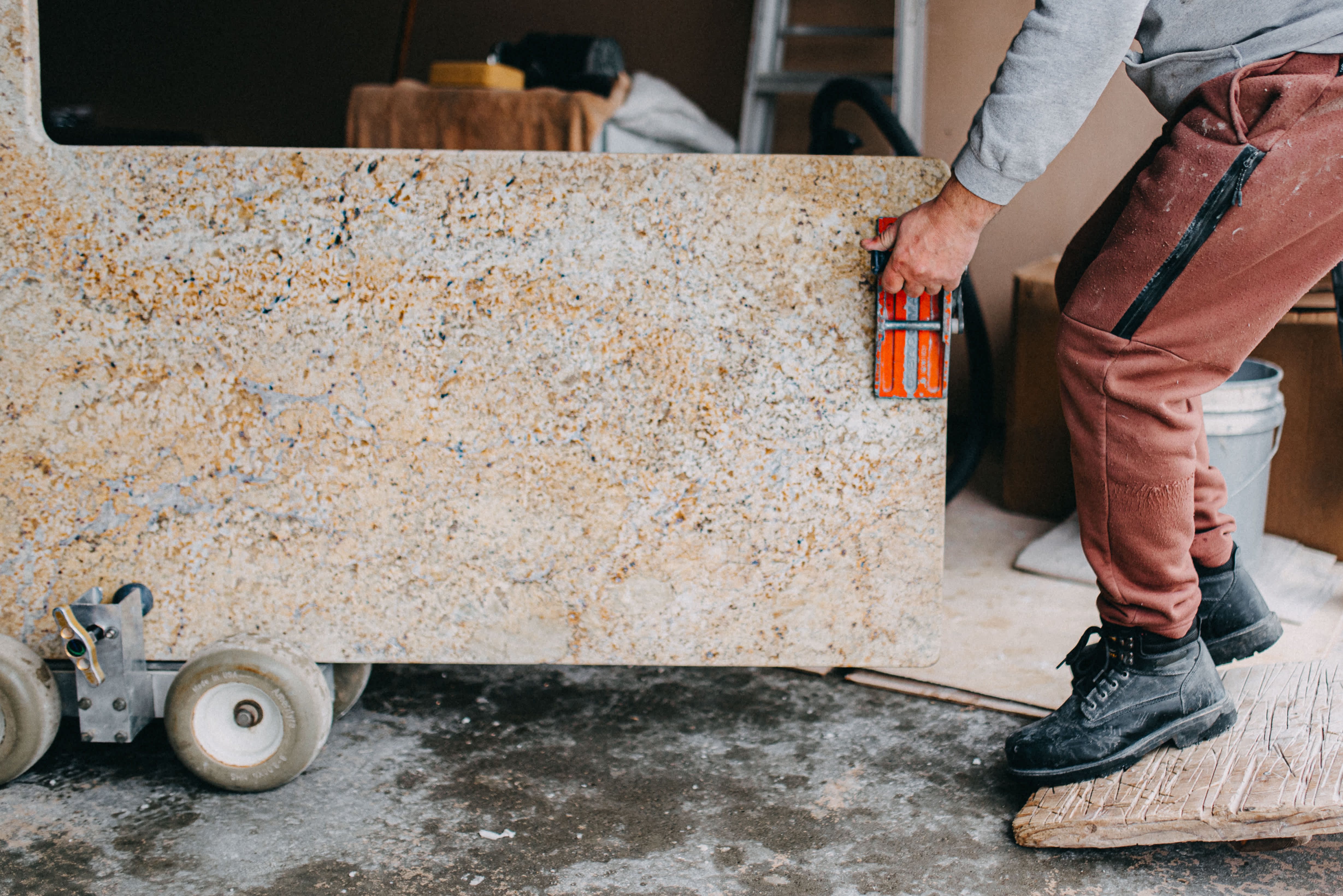 A professional moving a granite countertop