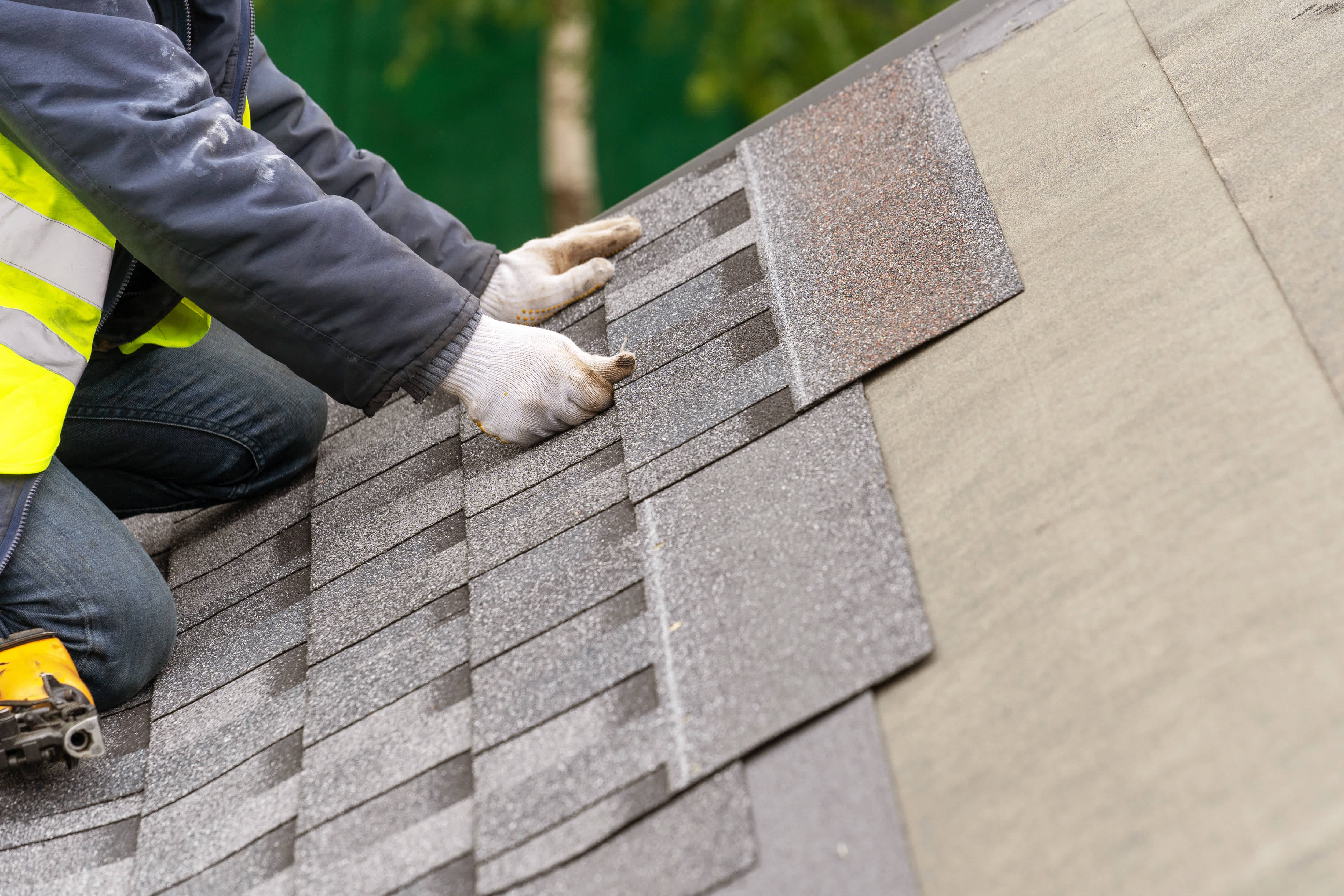 workman installing tile on roof