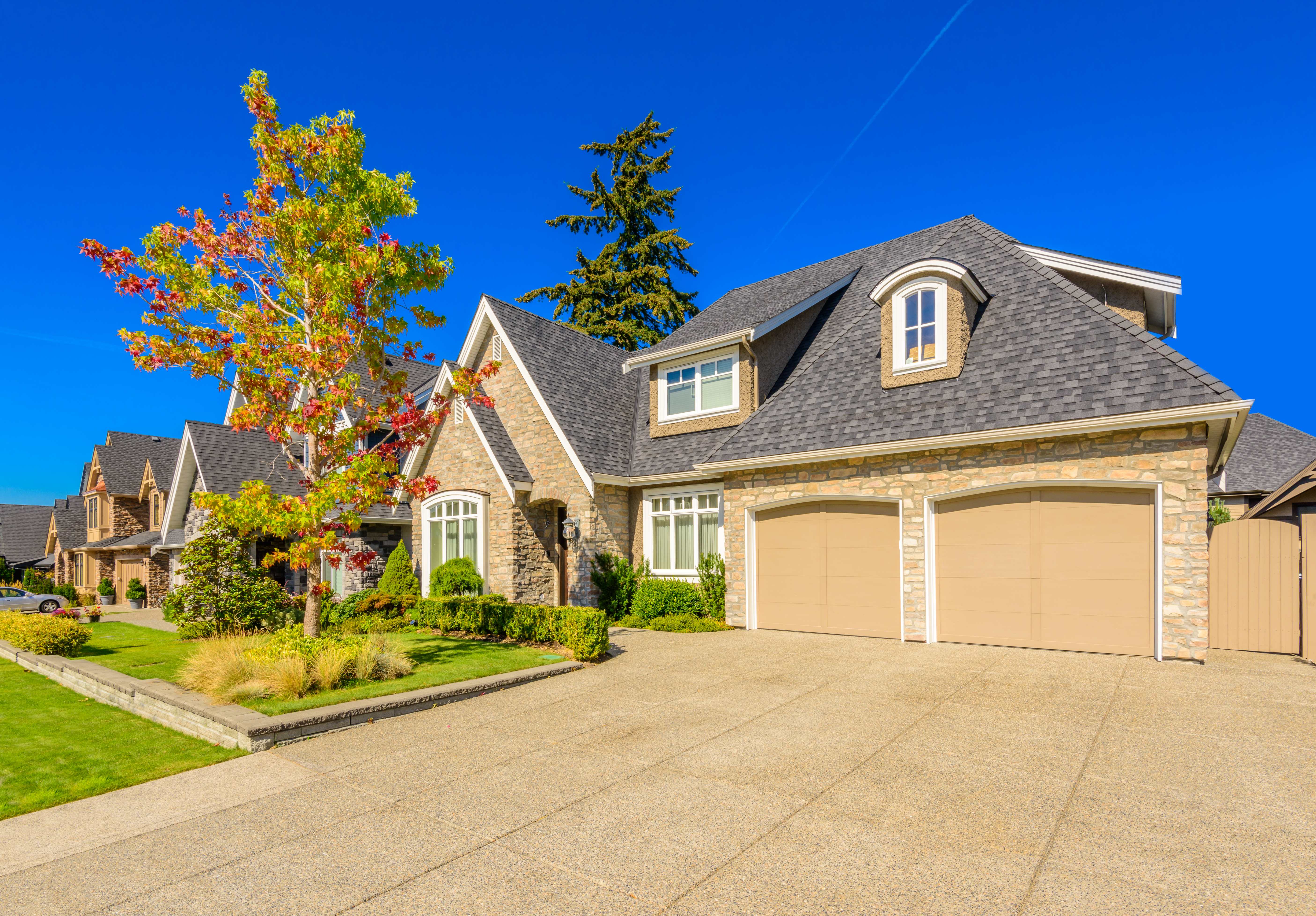 Houses with stone siding and asphalt shingle roof