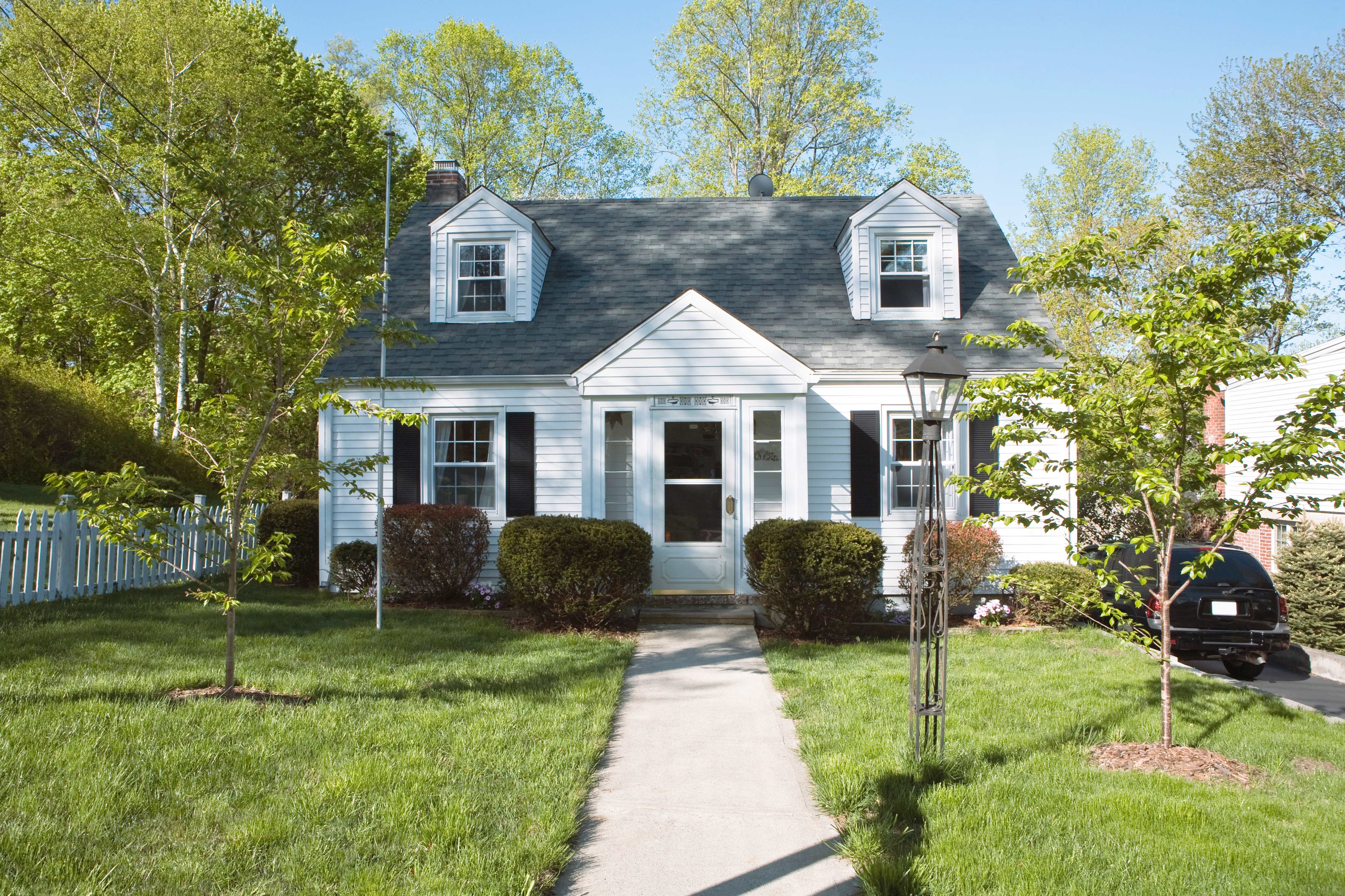 Single-family home with asphalt roof shingles and white siding