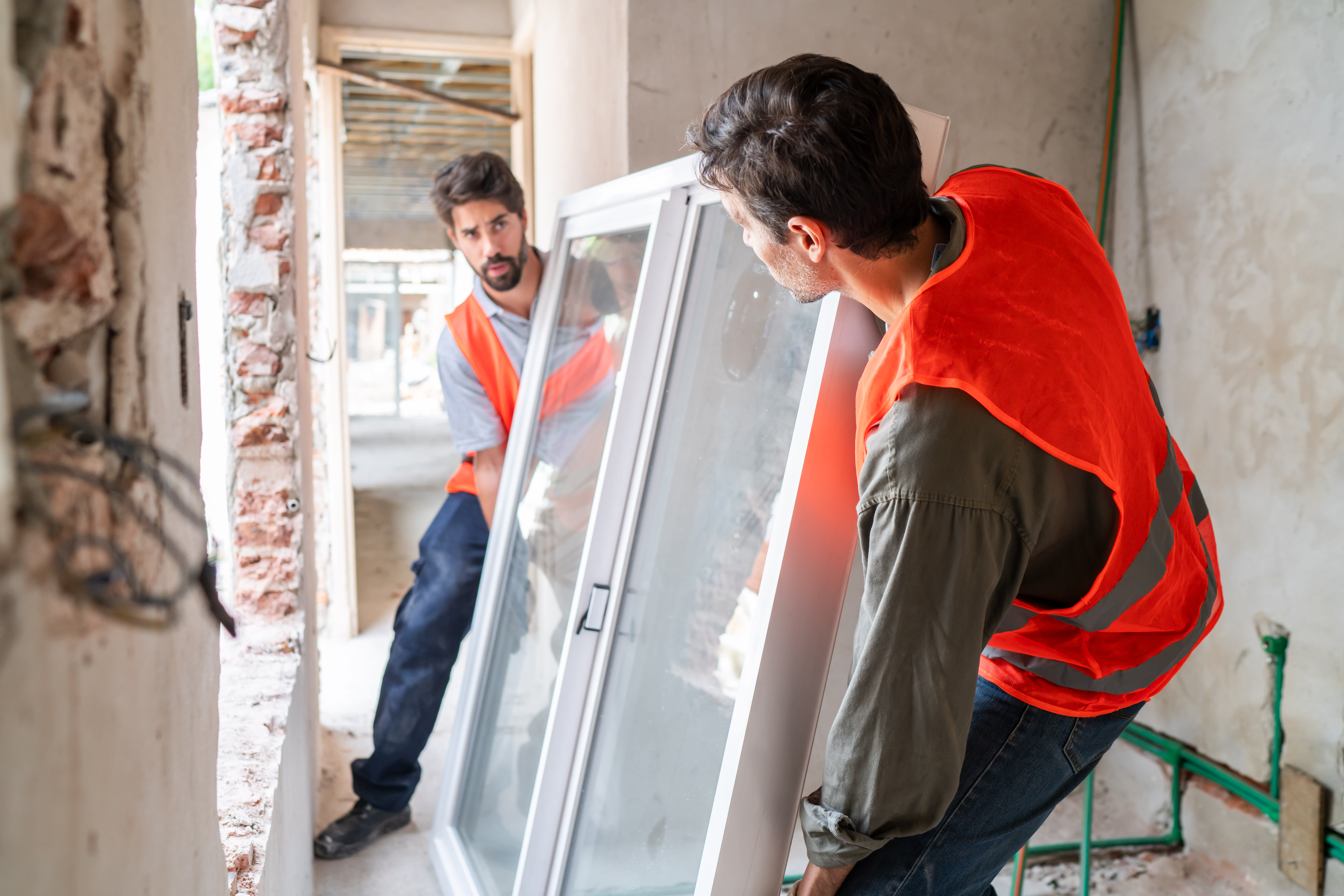 Two professionals installing a new window