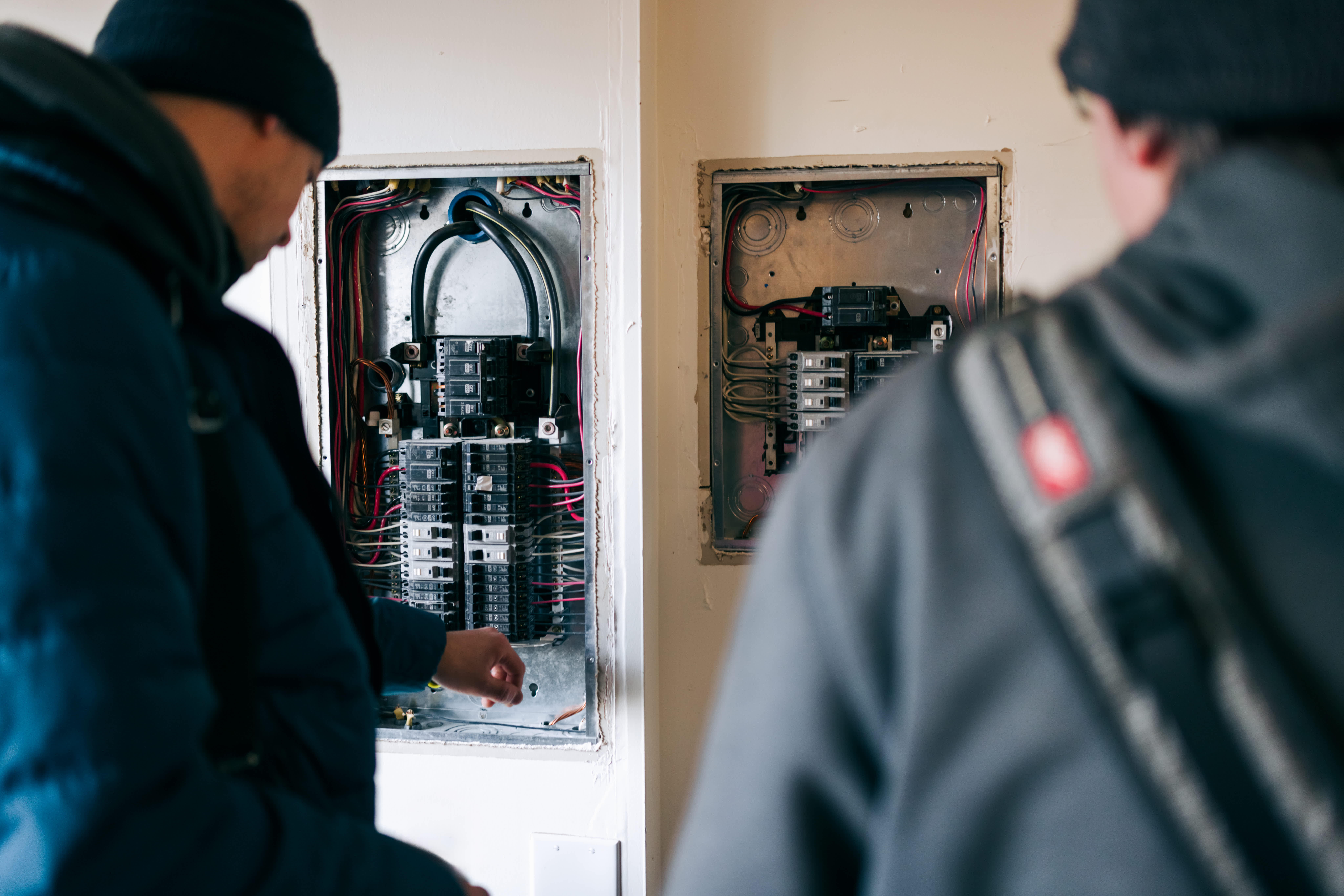 Electricians work on breaker box
