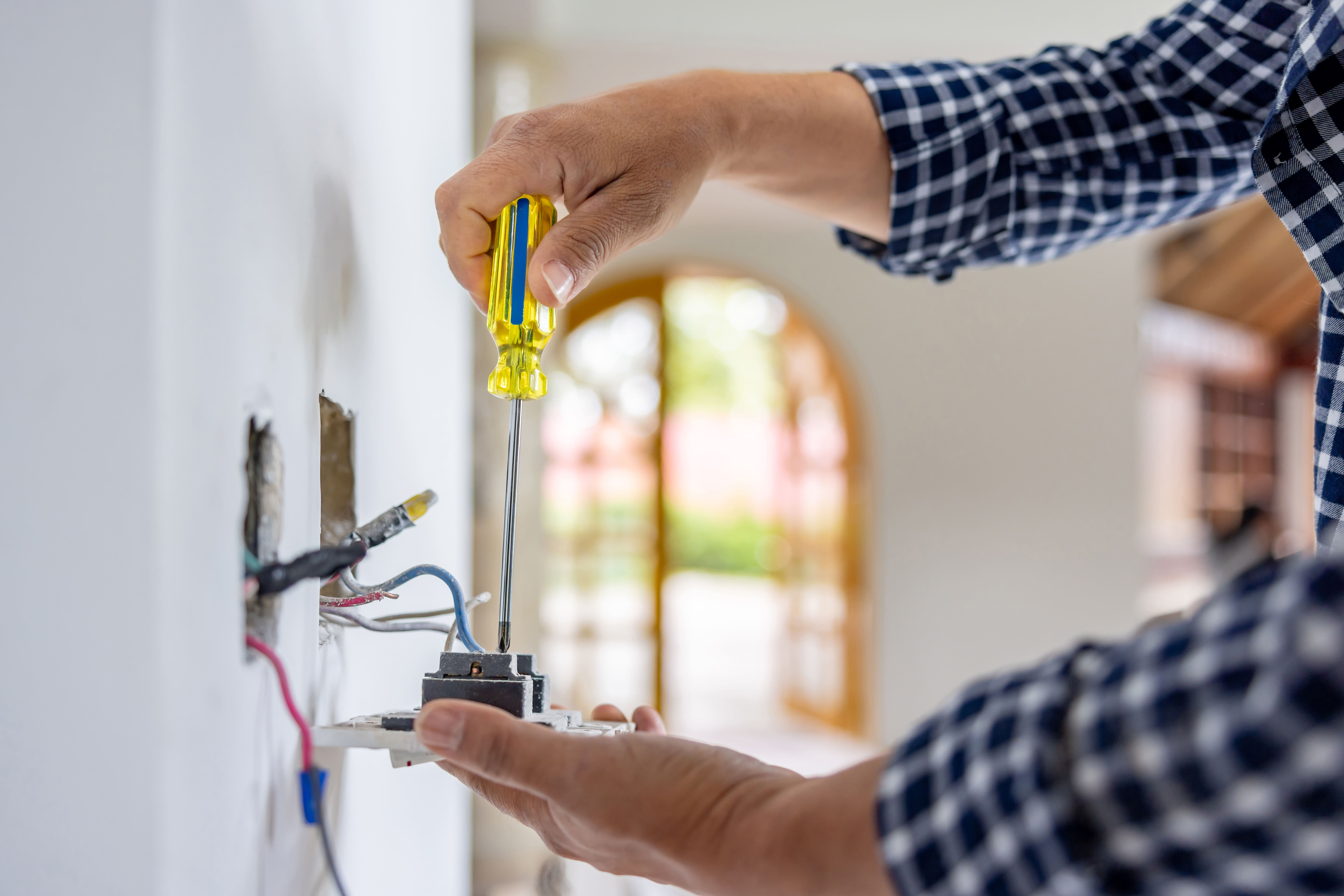 Electrician installing a power outlet