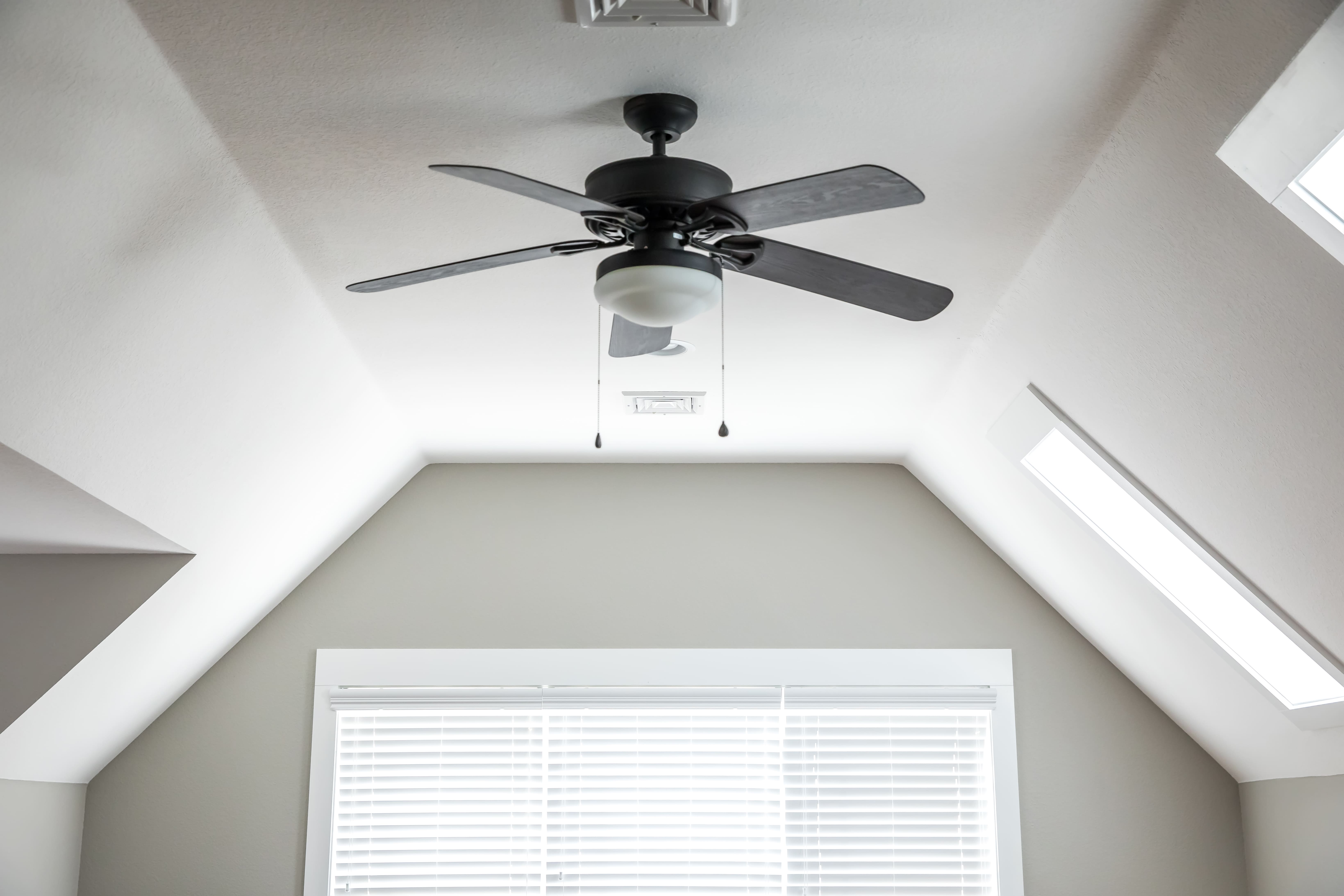 A dark wood ceiling fan