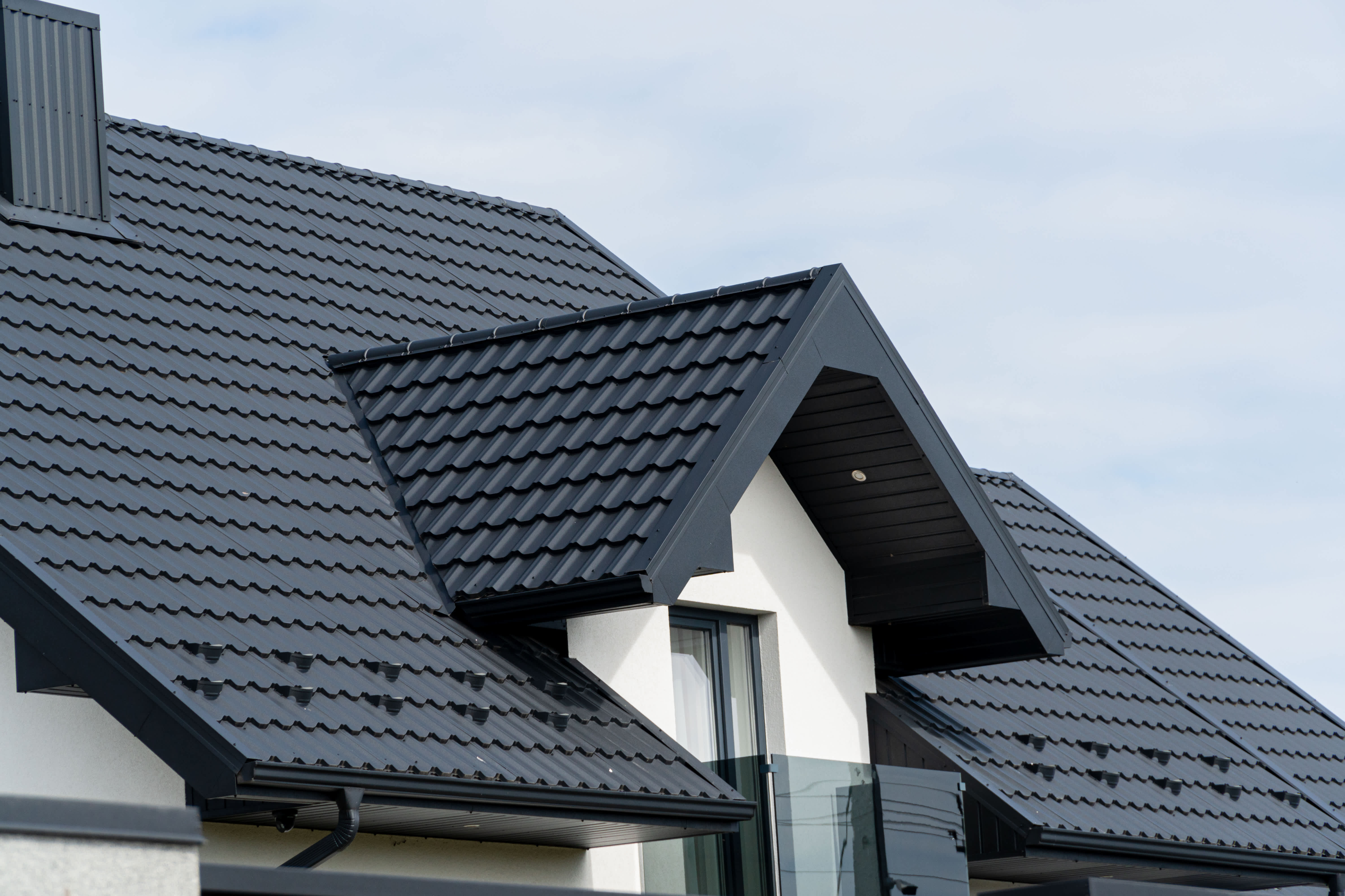Alt Text: Black metal roof installed on a house