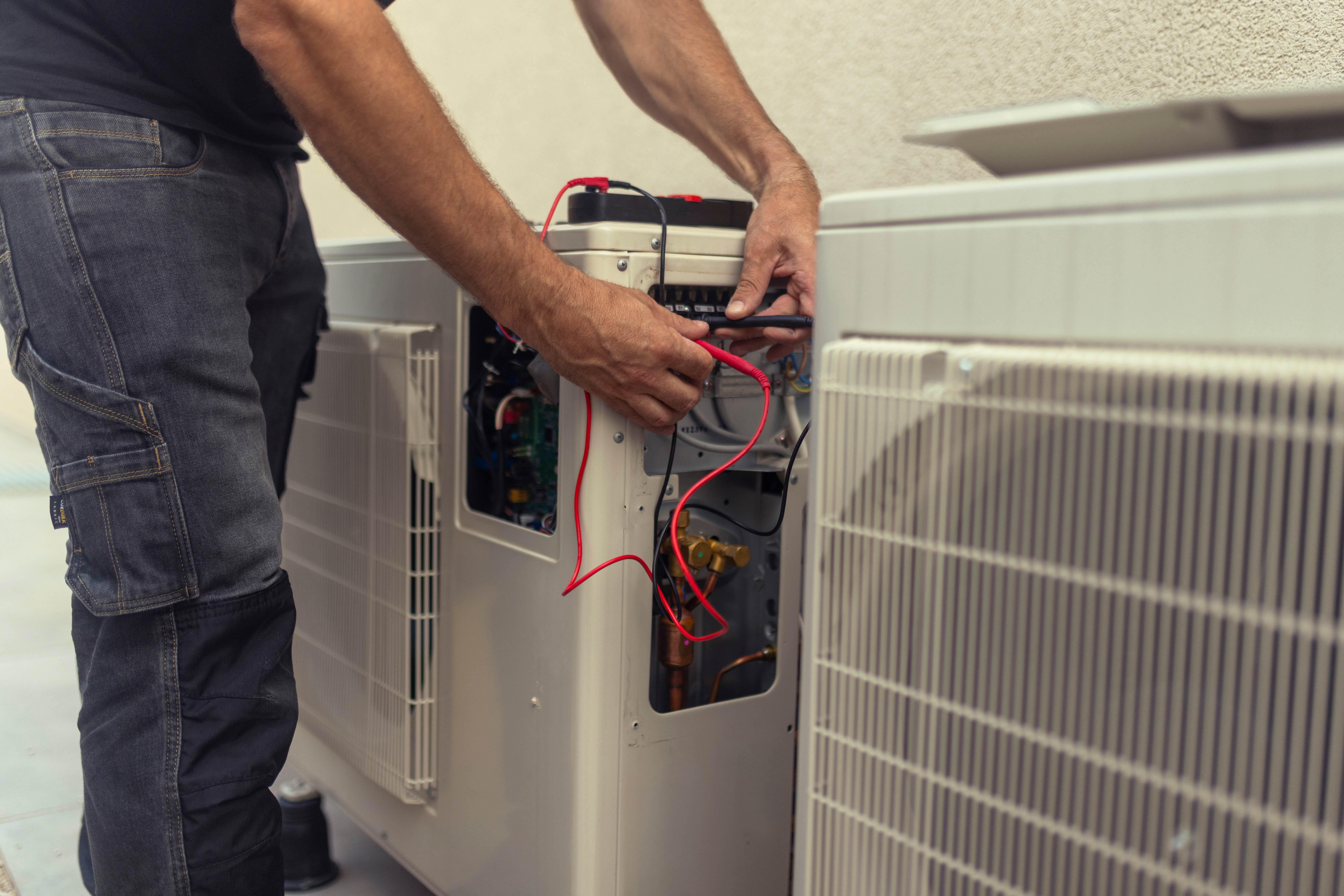 Electrician installing a heat pump